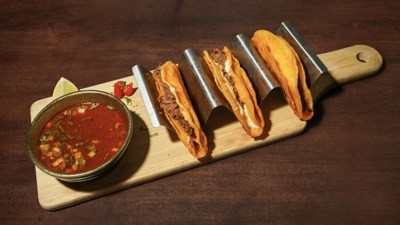 A beautifully arranged table with various dishes, including fruits, bread, and wine, set for a meal.