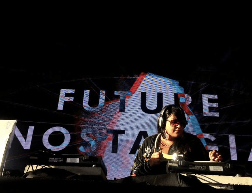 a group of women standing on top of a sandy beach