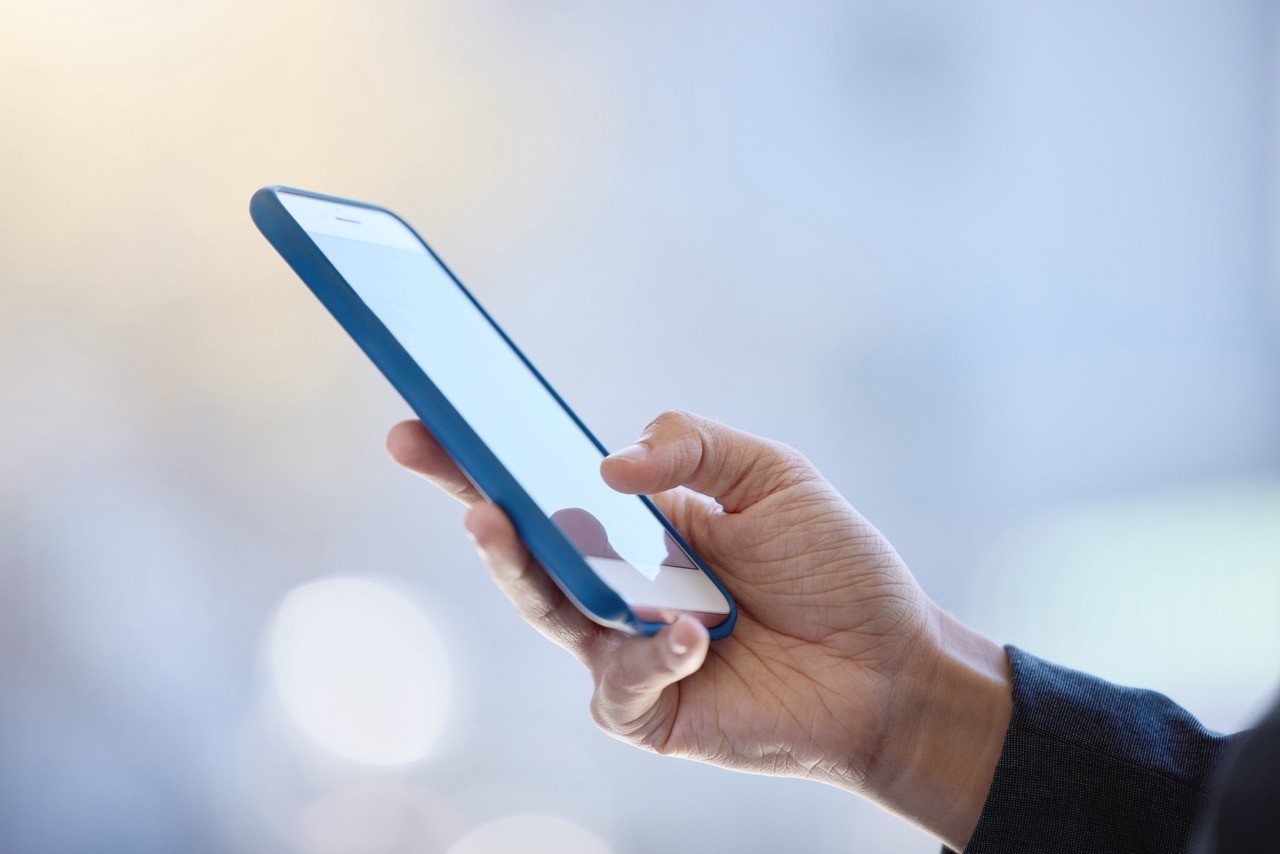 Close-up of a person's hand holding a smartphone, symbolizing immediate and accessible legal consultation with SAA Law Firm.