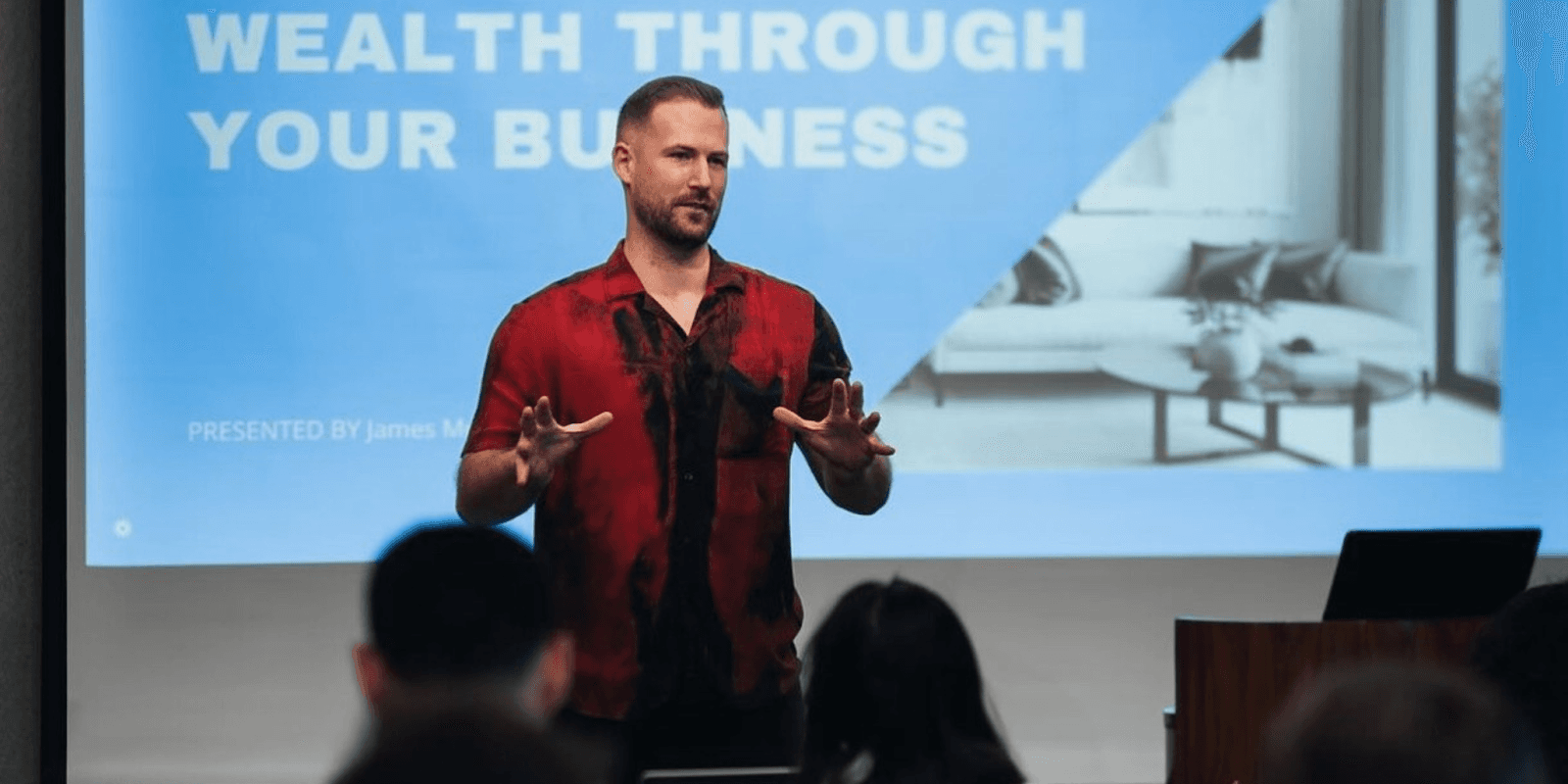 James Z Murphy presenting strategies for scaling profitable Airbnb businesses at a seminar.