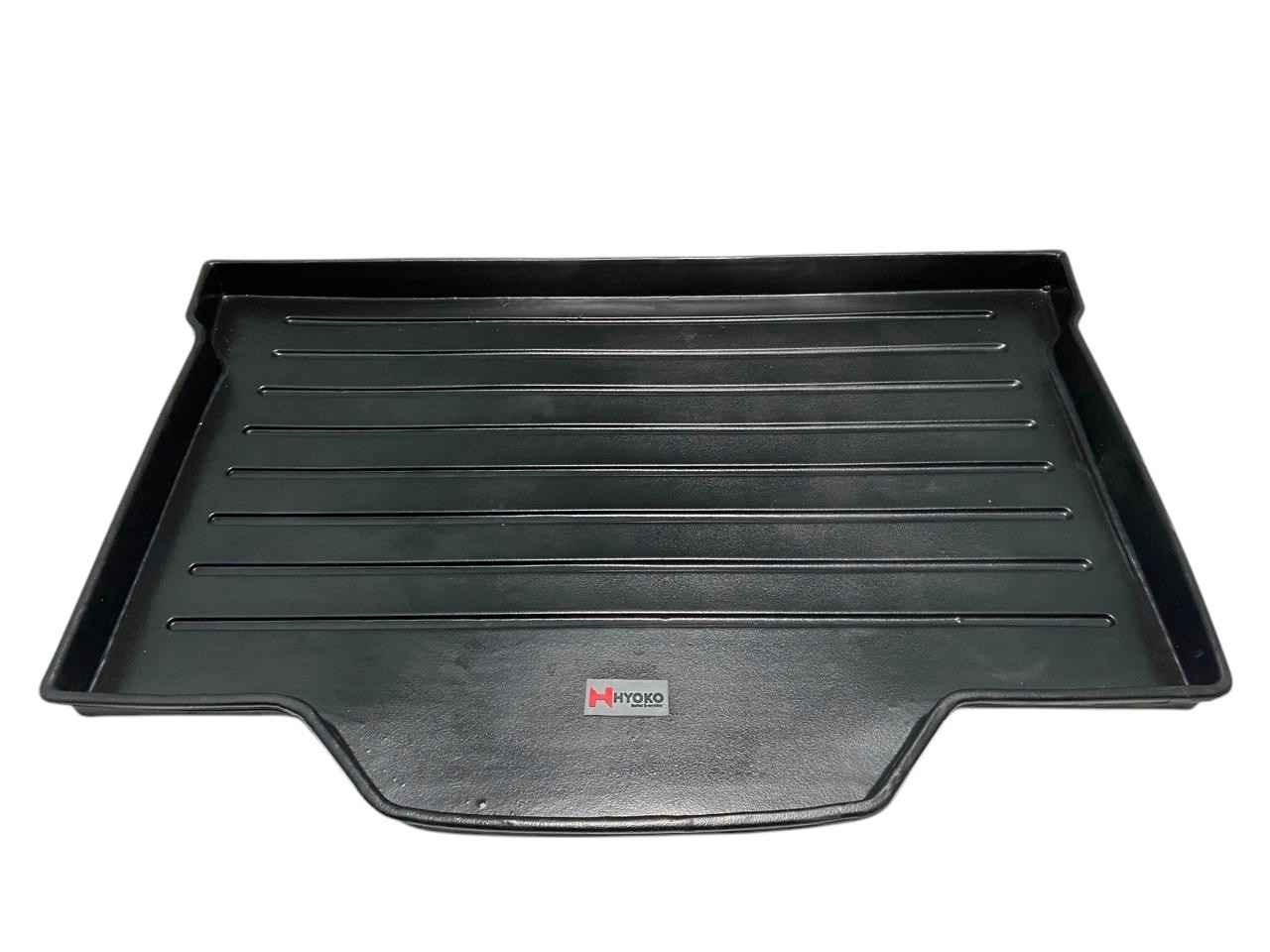 Interior view of a car trunk featuring a black rubber mat with a textured surface and outlined sections.