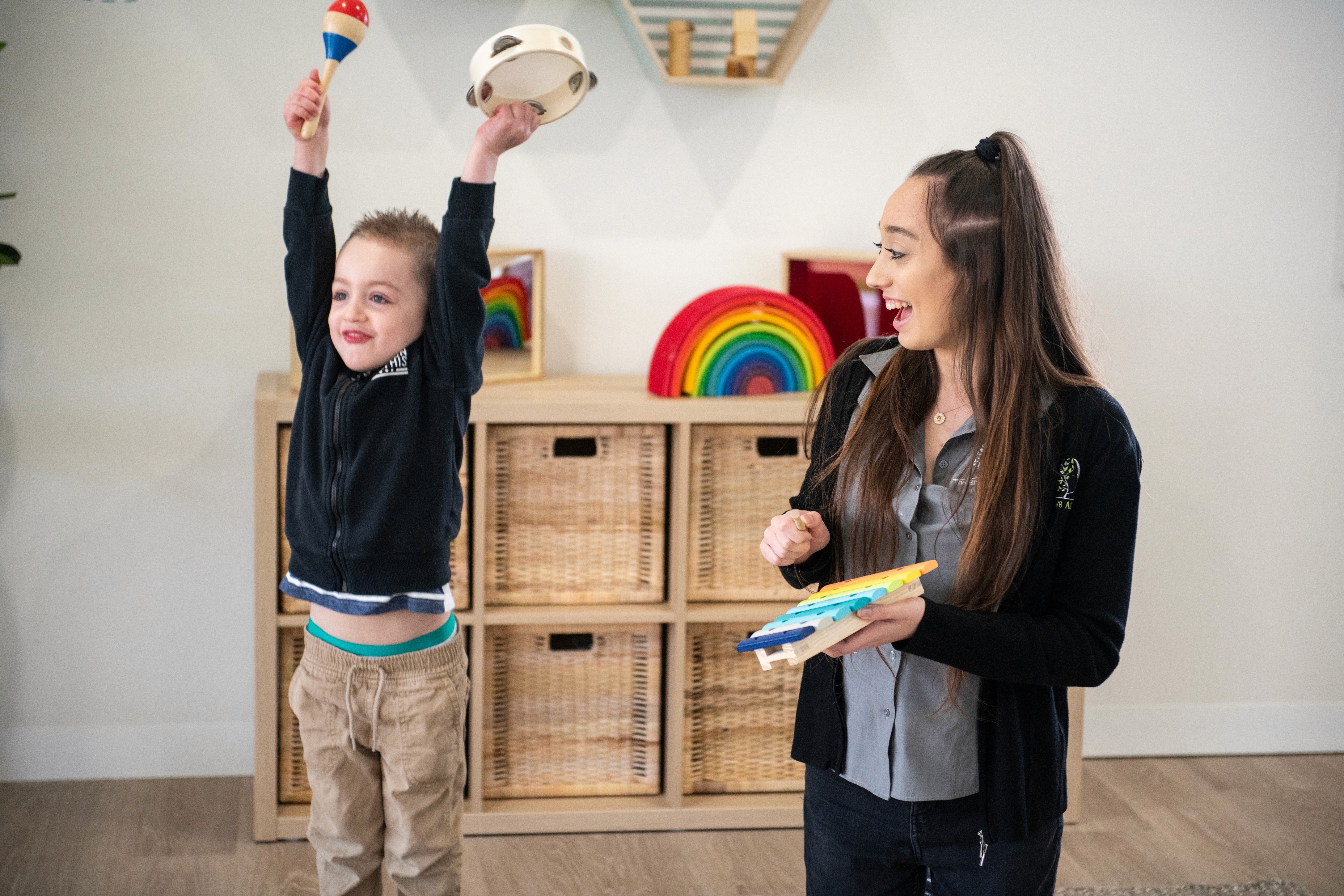 Close-up of a dark green leaf showing its textured surface and central vein against a muted background.