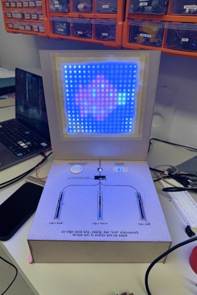An earlier white Mix A Pixel prototype with a glowing LED grid and three sliders