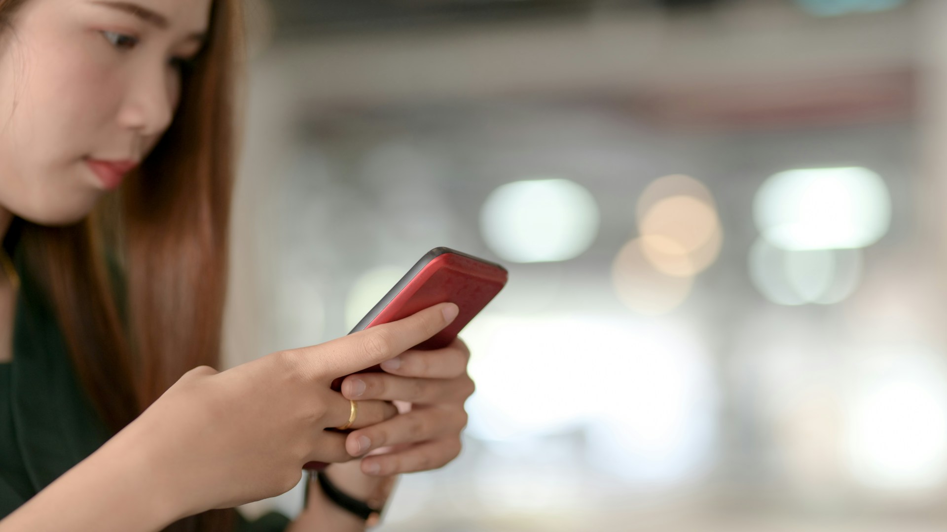 A photo of a woman holding her phone
