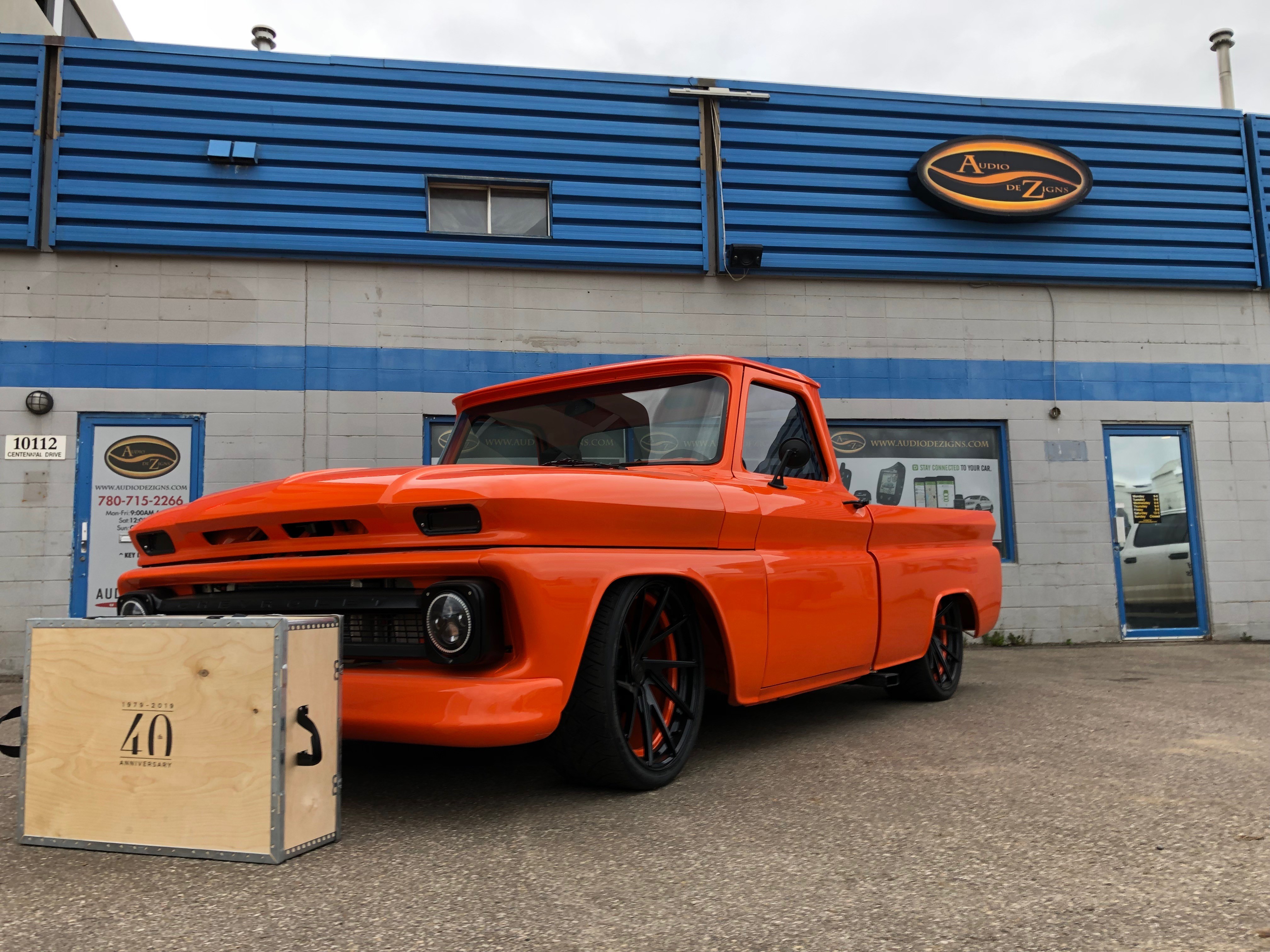 A fast black sports car races down the highway.