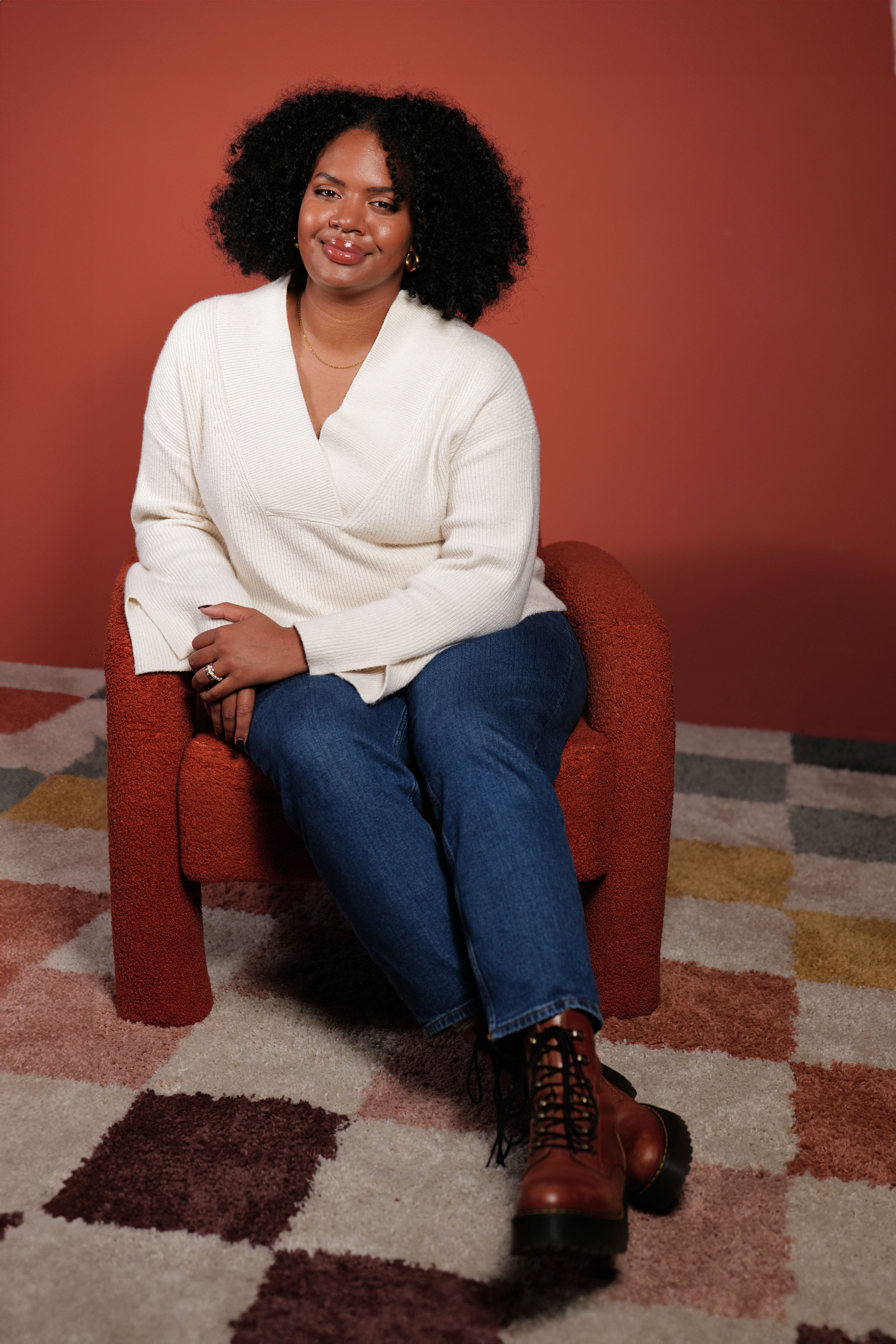 A photo of the Vice President of Business Development Ravyn Pierce sitting on a chair