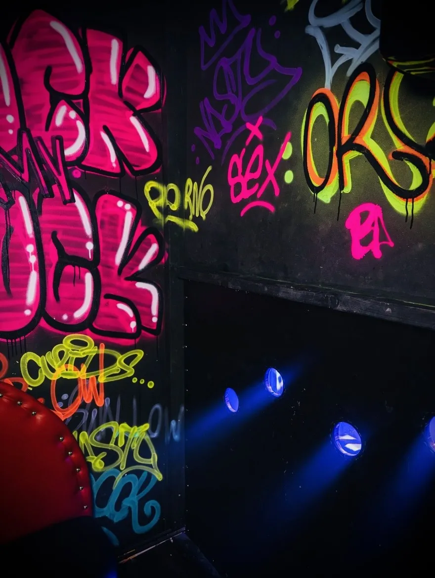 Colourful graffiti wall and stage lighting inside Nocturne Club