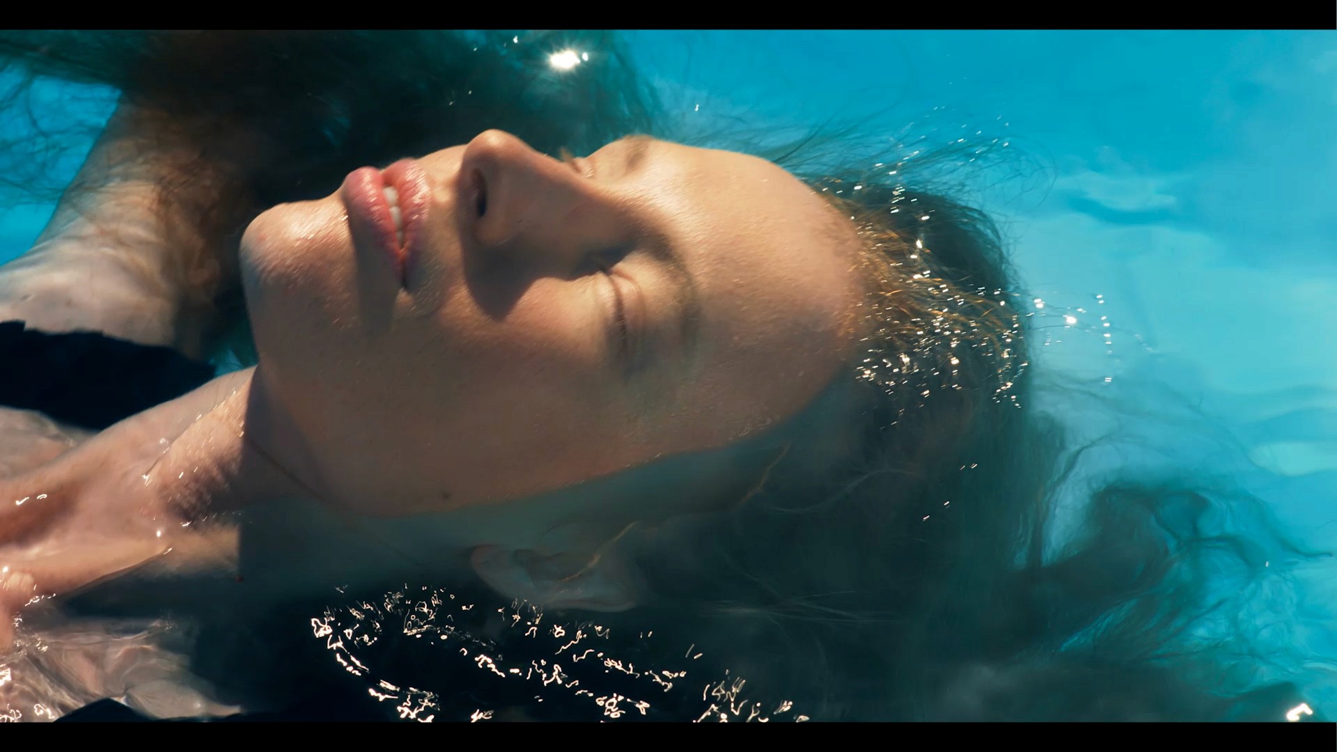 Woman relaxing in the water during the filmmaking of the commercial