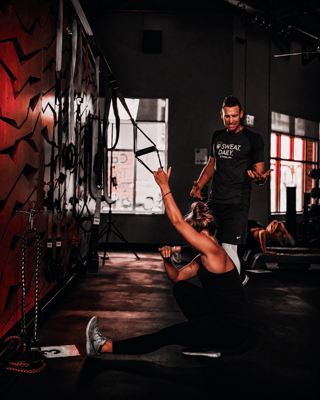 a gym with a row of exercise machines
