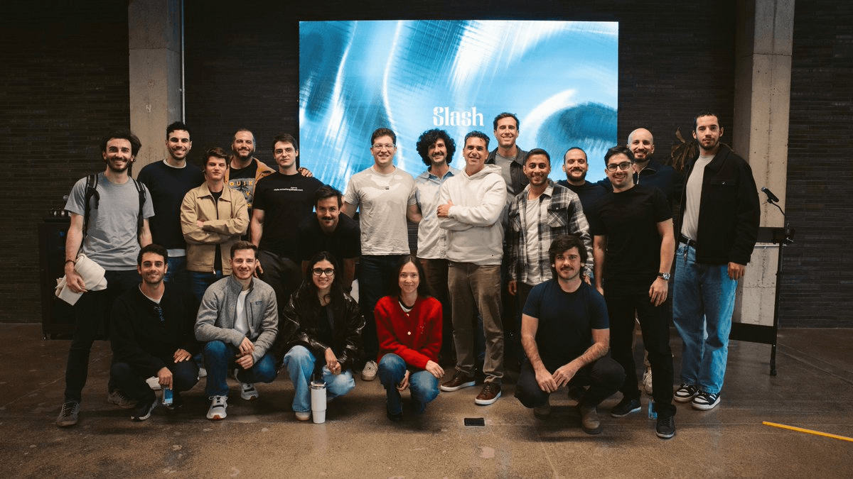 Contrario team posed on stage in front of a Slash backdrop at the company launch