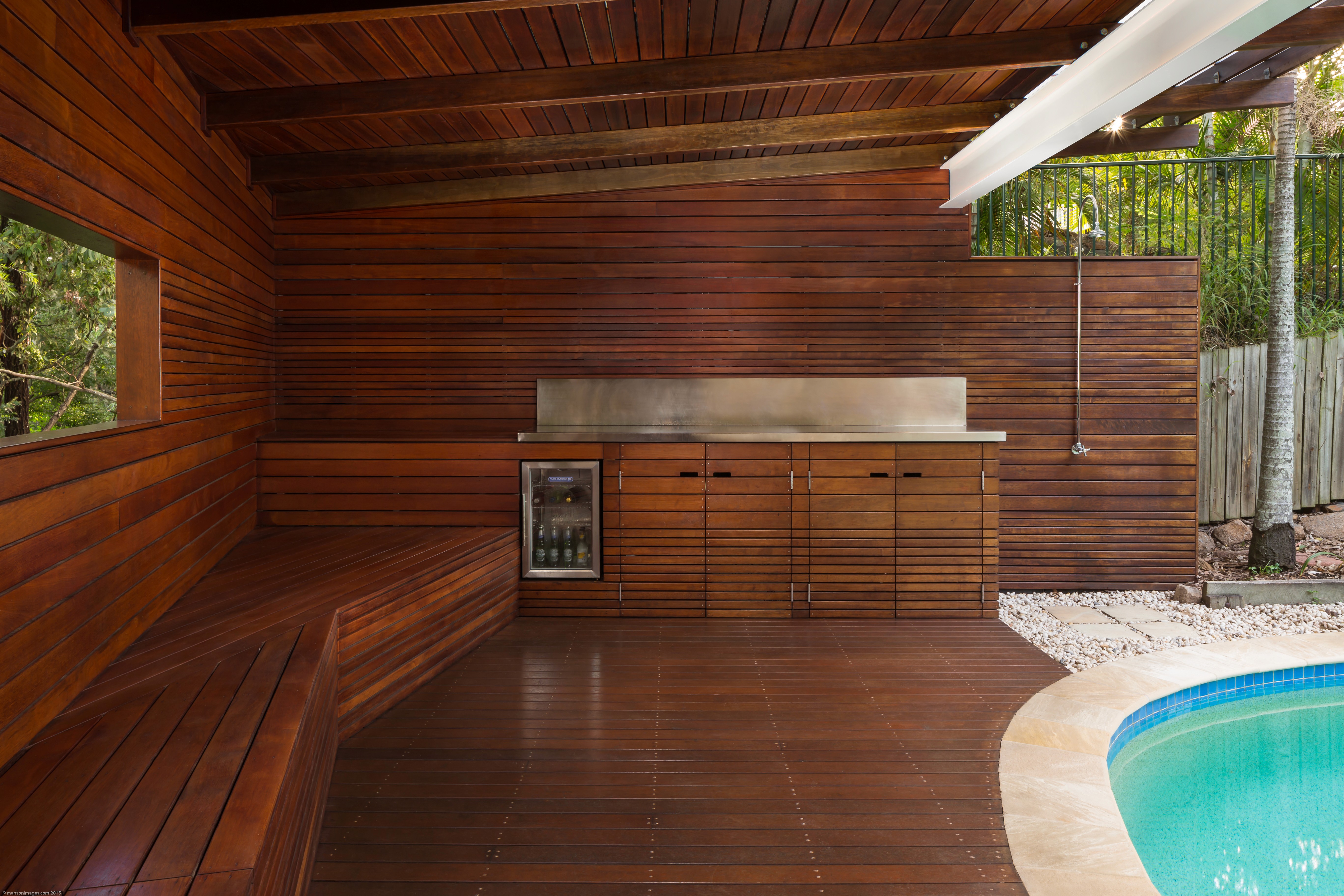 Timber kitchenette and storage within Wattle Pavilion, integrated into the poolside structure and designed for outdoor entertaining.