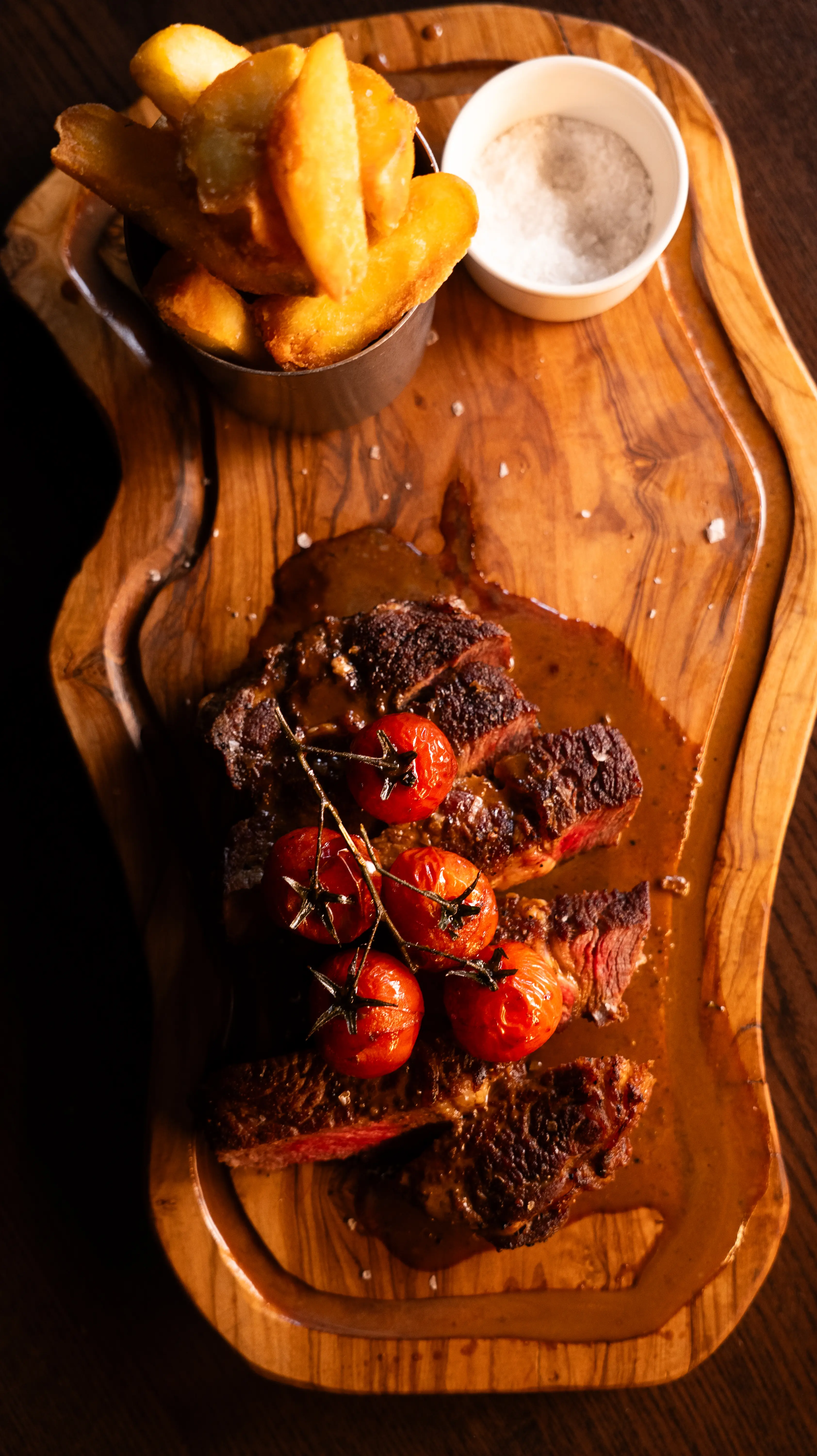 Steak and chips on a wooden board the The Gun pub in London