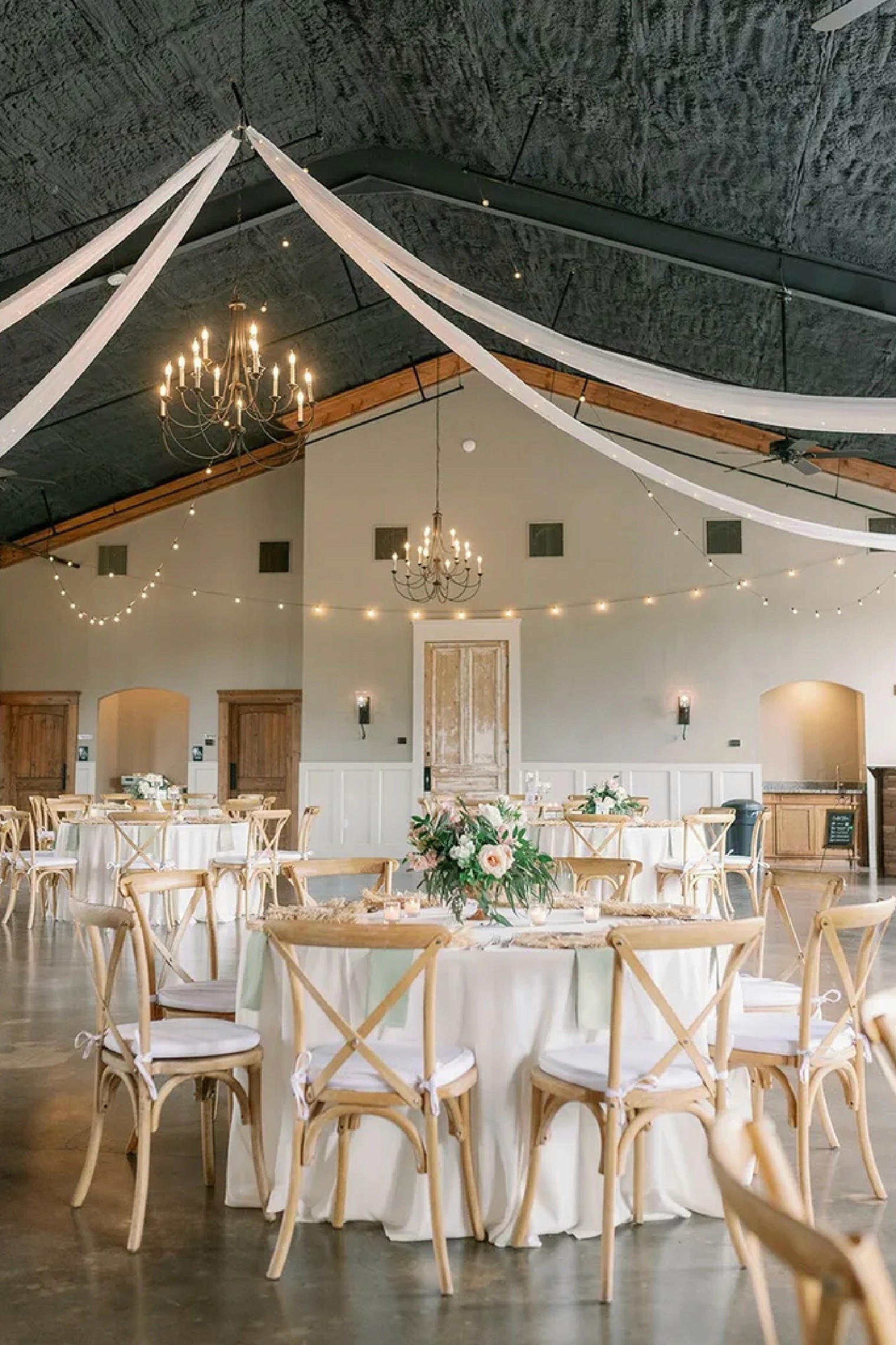 A couple stands outdoors at sunset.