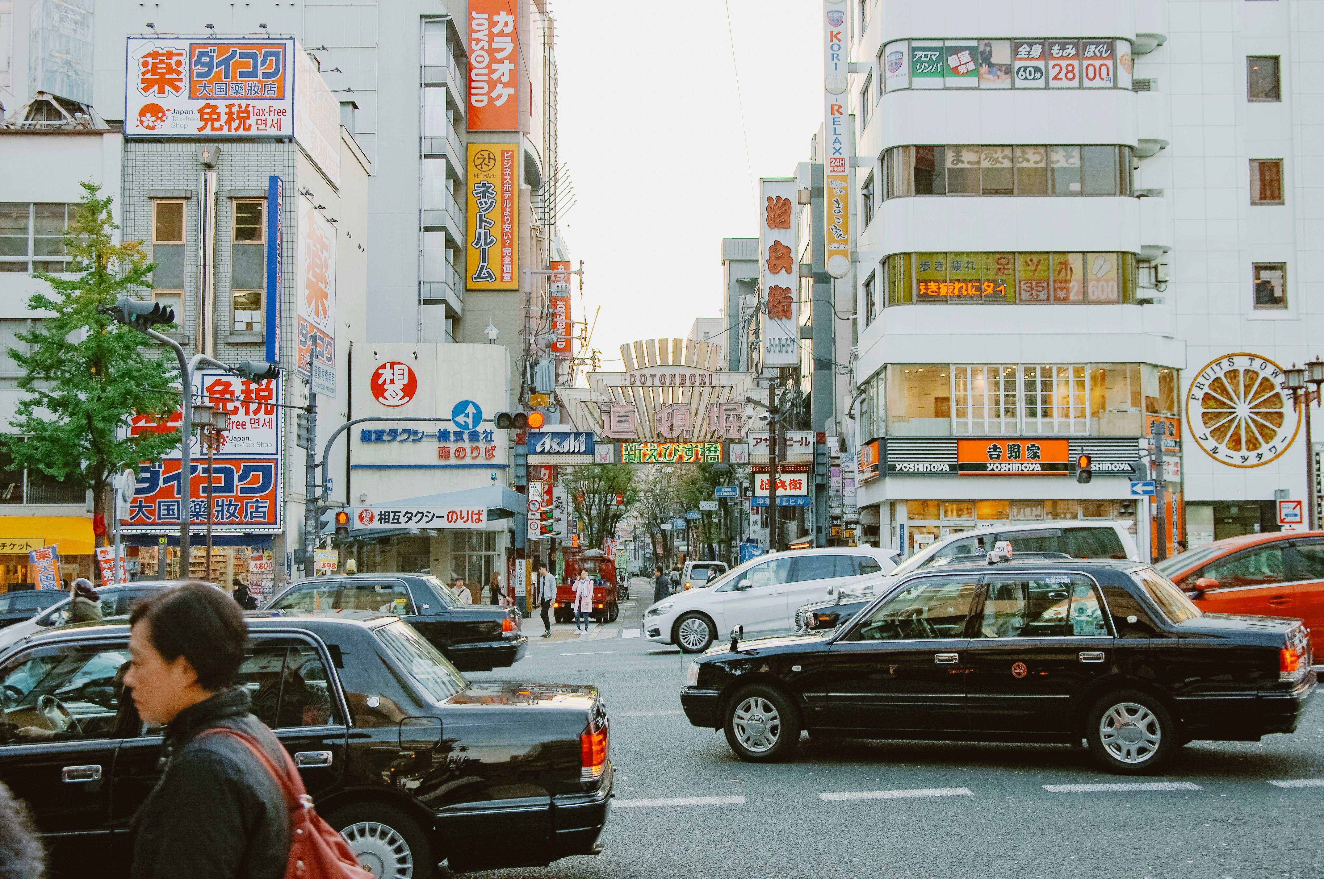 Busy street with cars and buildings in japan.