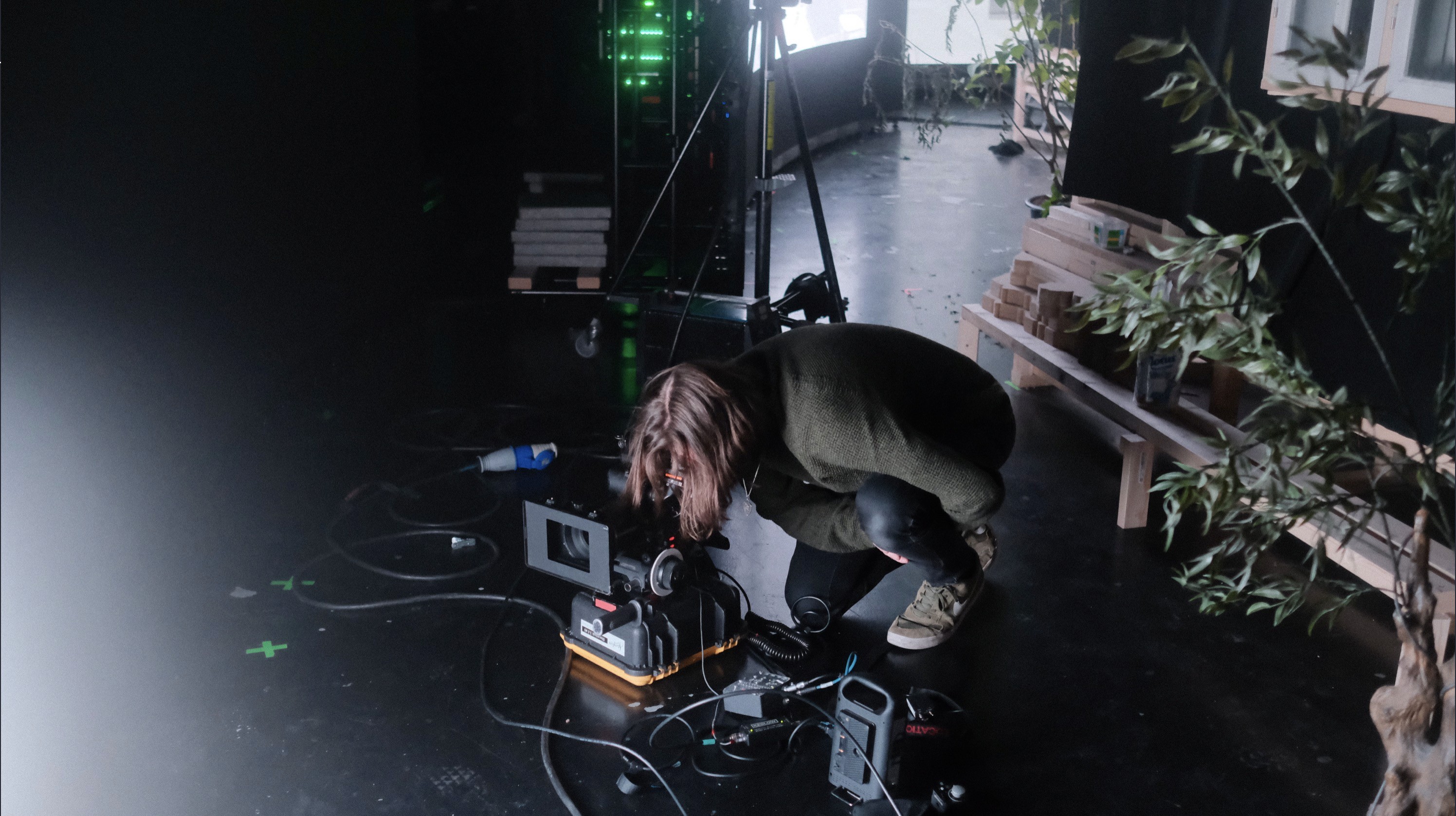 Person rigging a camera in a virtual production studio.