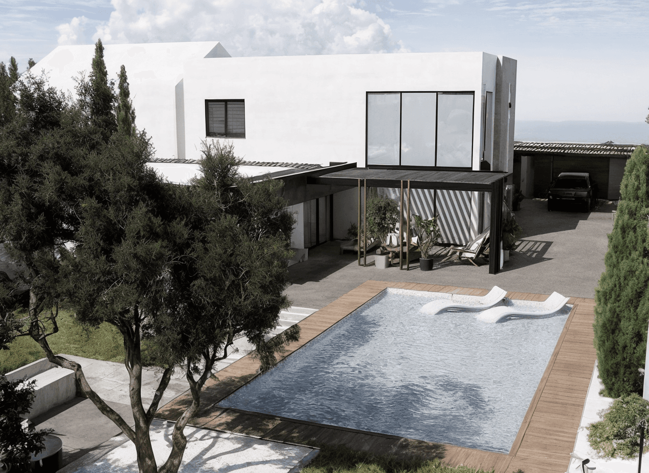 Front view of a modern wooden architecture building on grass with blue sky.