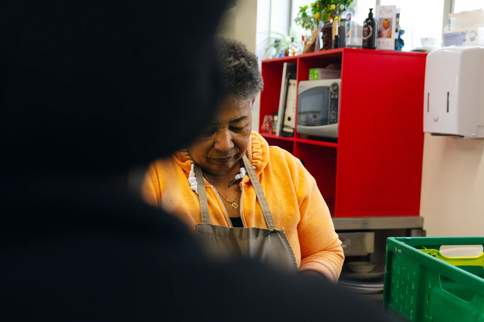 Two people talking in a kitchen service area
