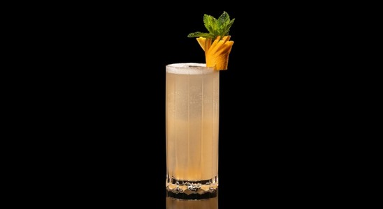 A closeup of a Miami Spritz drink against a dark background.