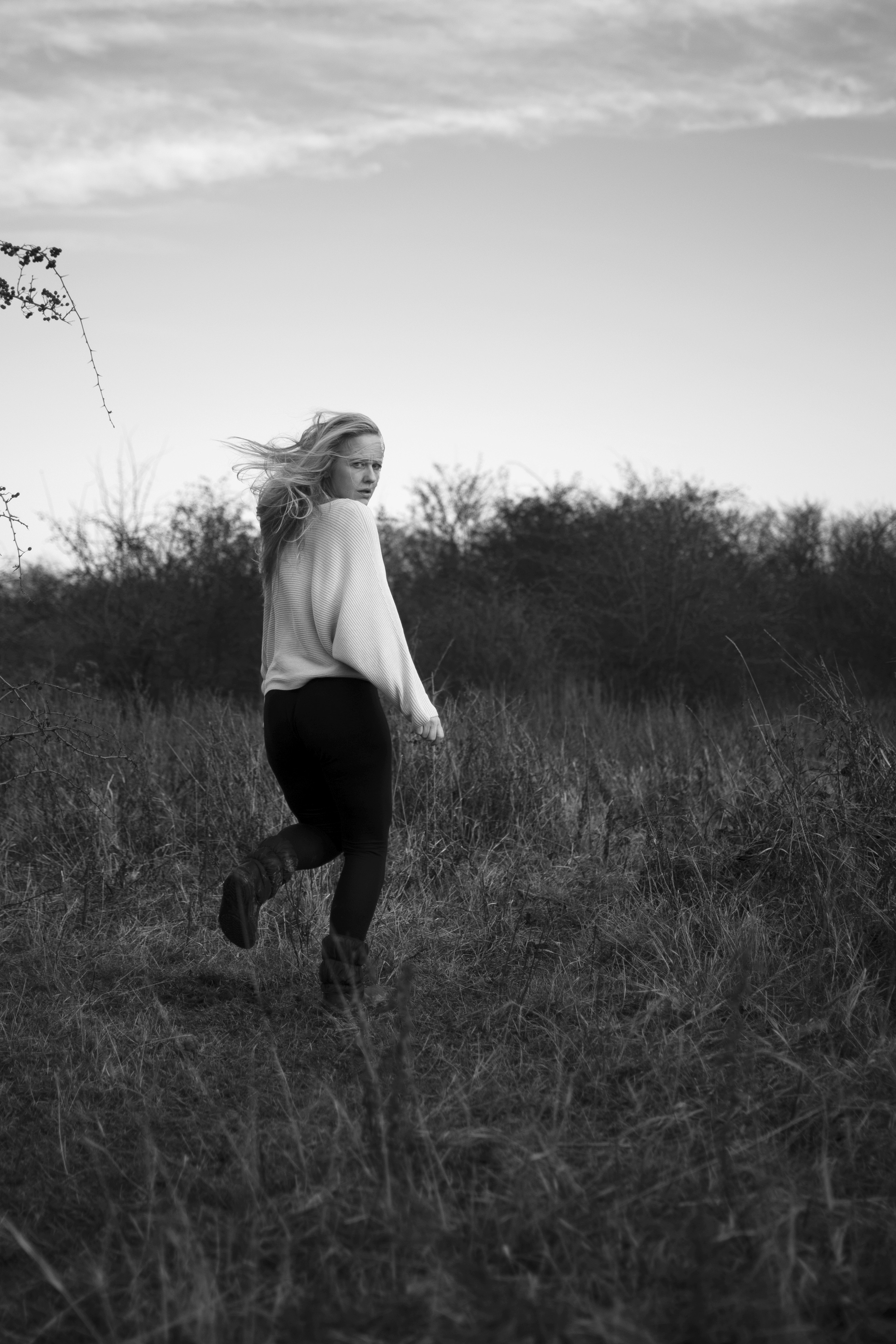 Bold editorial fashion portrait of model in houndstooth blazer with red tie and green shirt against bright turquoise background - Serif Creative Studio luxury fashion photography