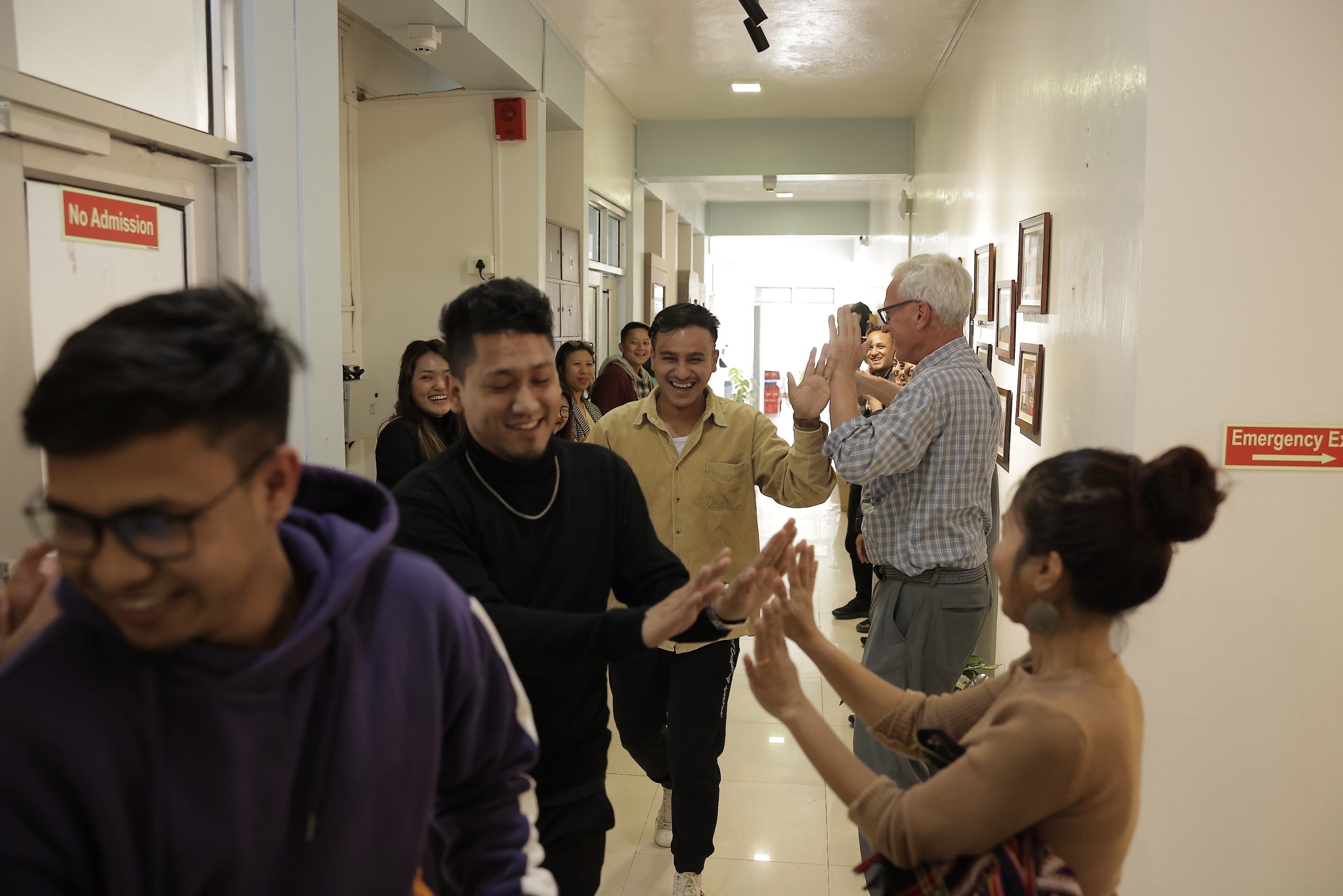 Group of people cheering in the corridor