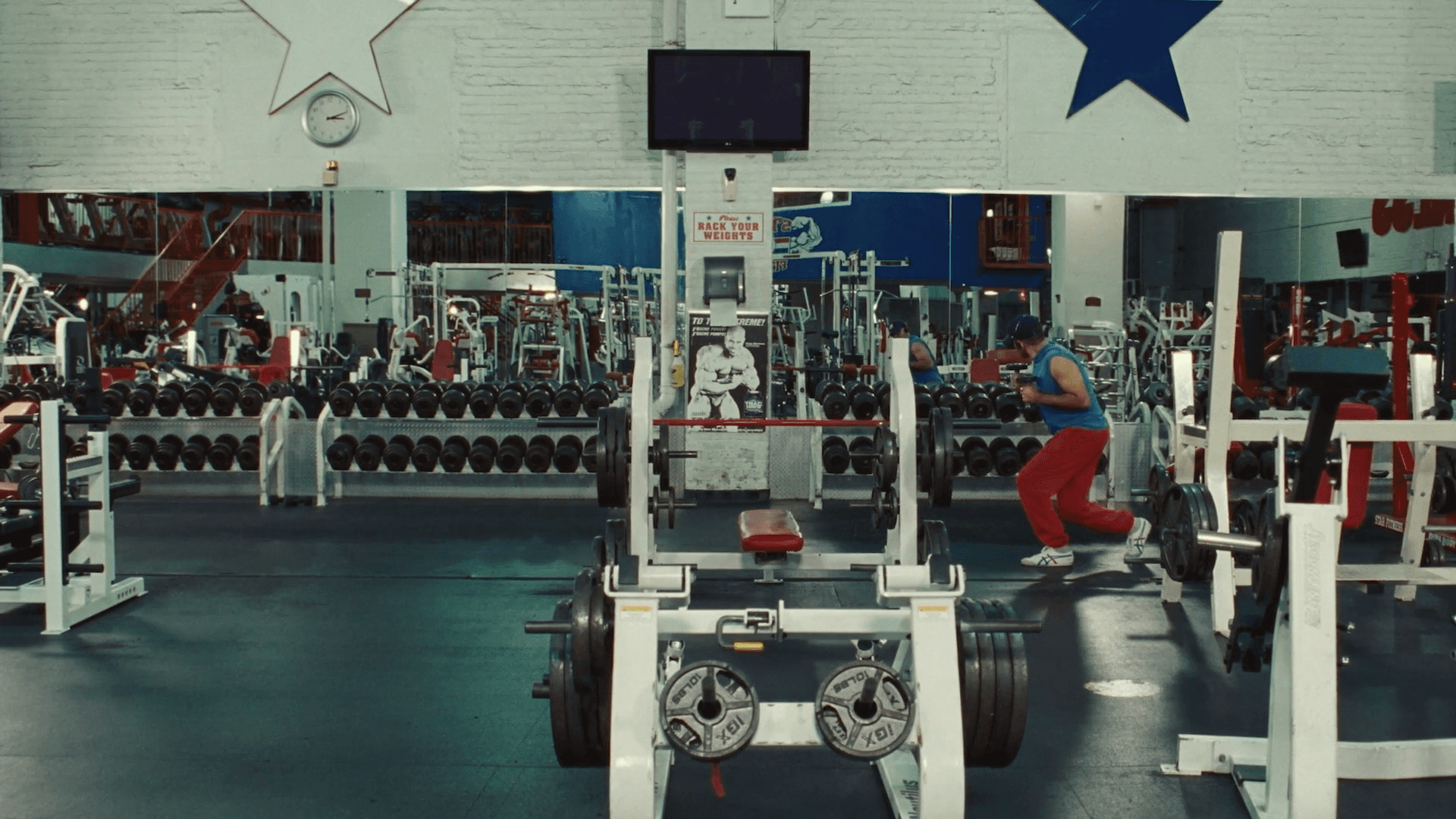 Silhouetted crowd observes pyramid through large windows.