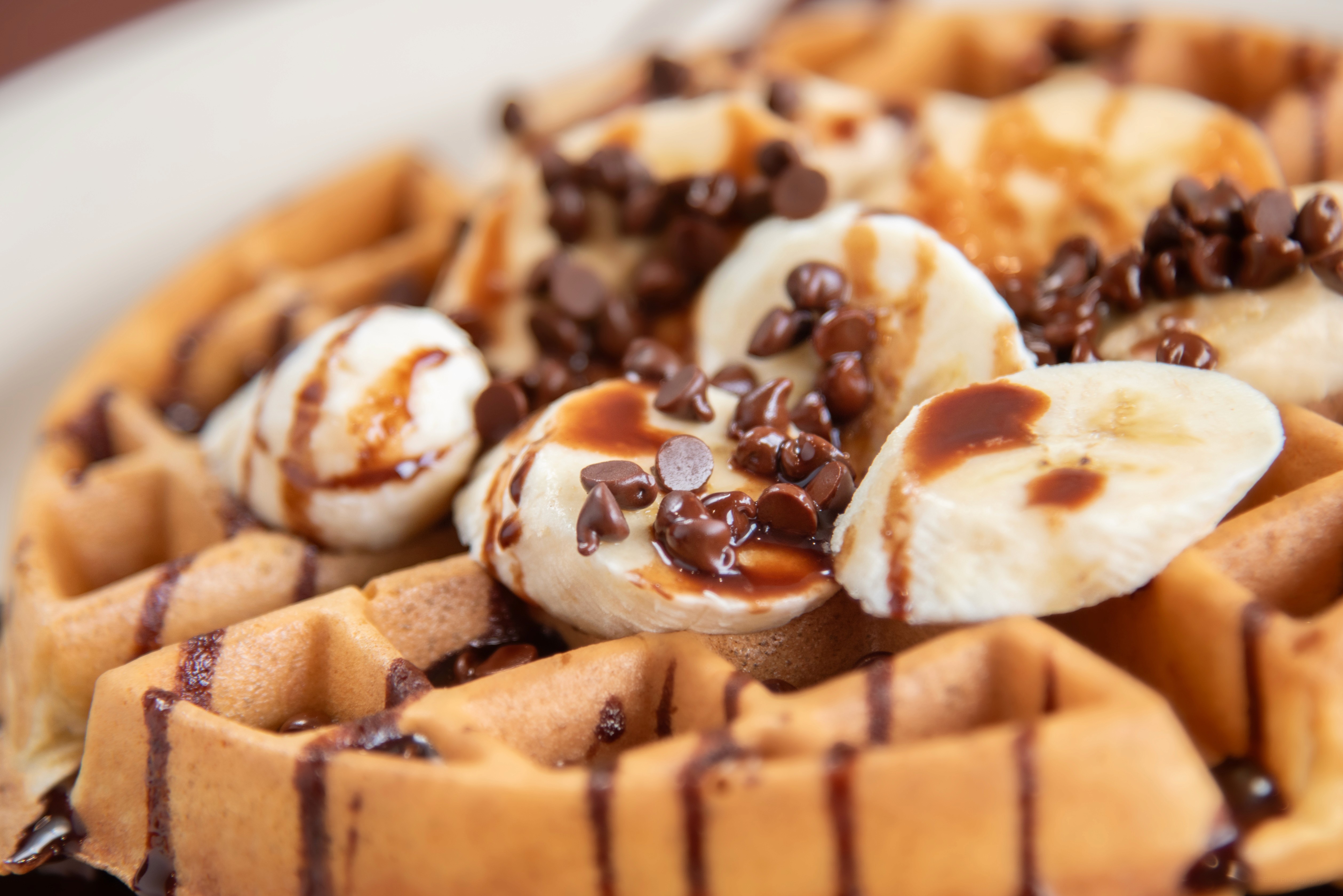 black and red cherries on white bowl