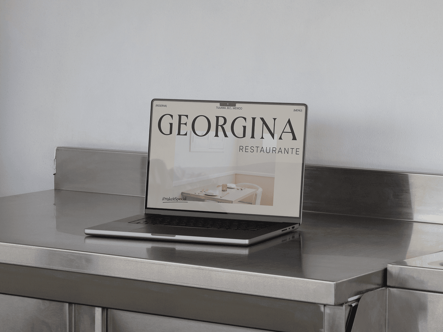 Restaurant homepage on a laptop on a steel kitchen counter