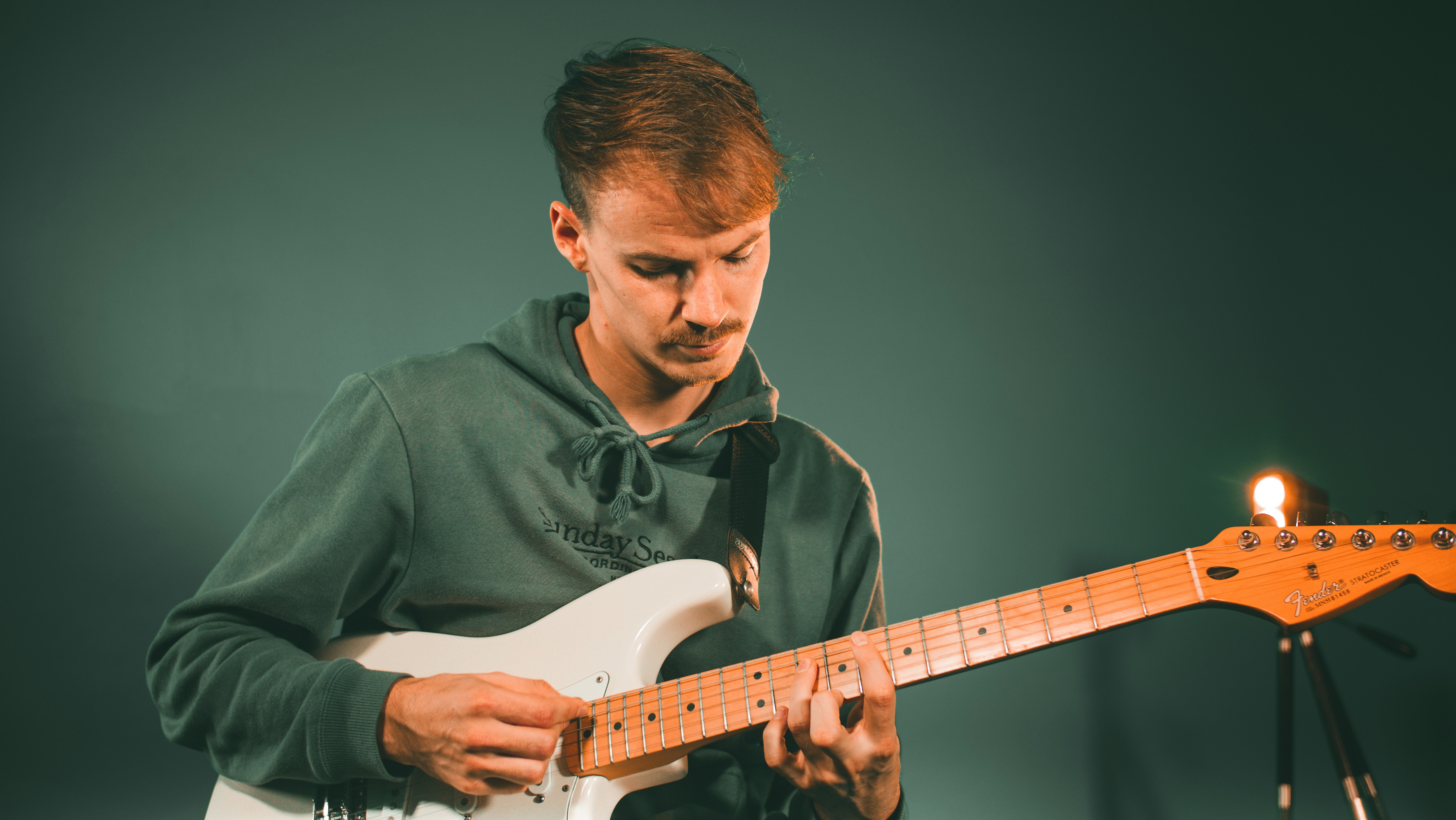 Man fretting a guitar