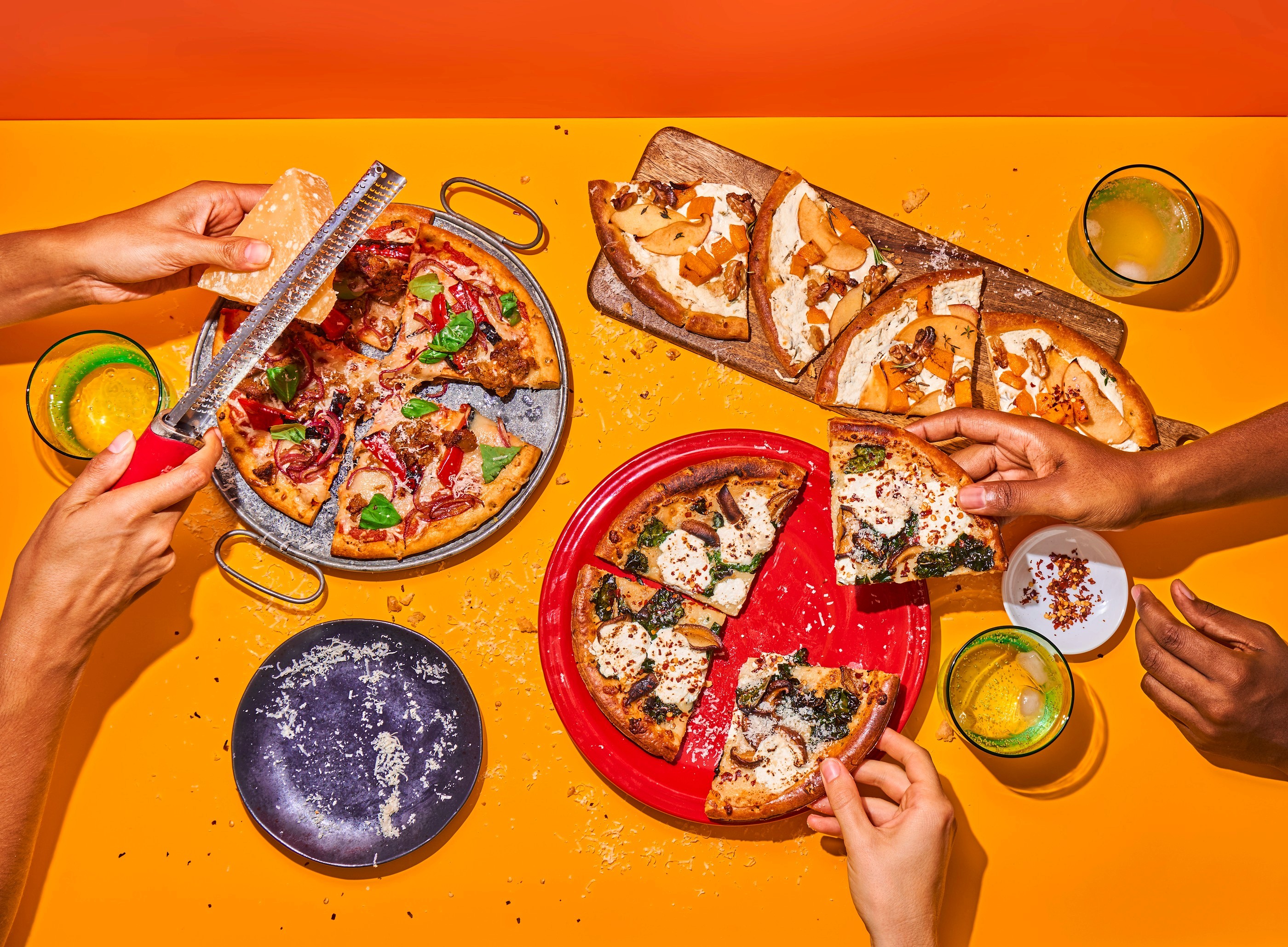 Pizza spread and serving hands