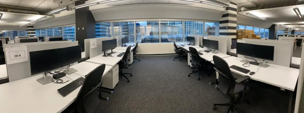Modern office workspace with computer equipment prepared for IT asset disposition, including secure removal and lifecycle management of IT devices