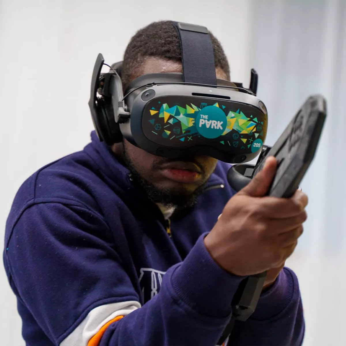 A person wearing a VR headset and holding a controller, getting mission-ready with the latest VR technology at The Park.