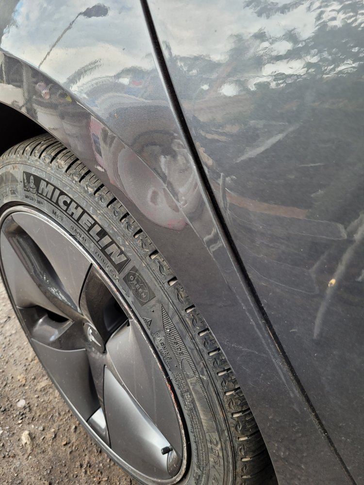 Tesla Model 3 fender dent from a gas station pole