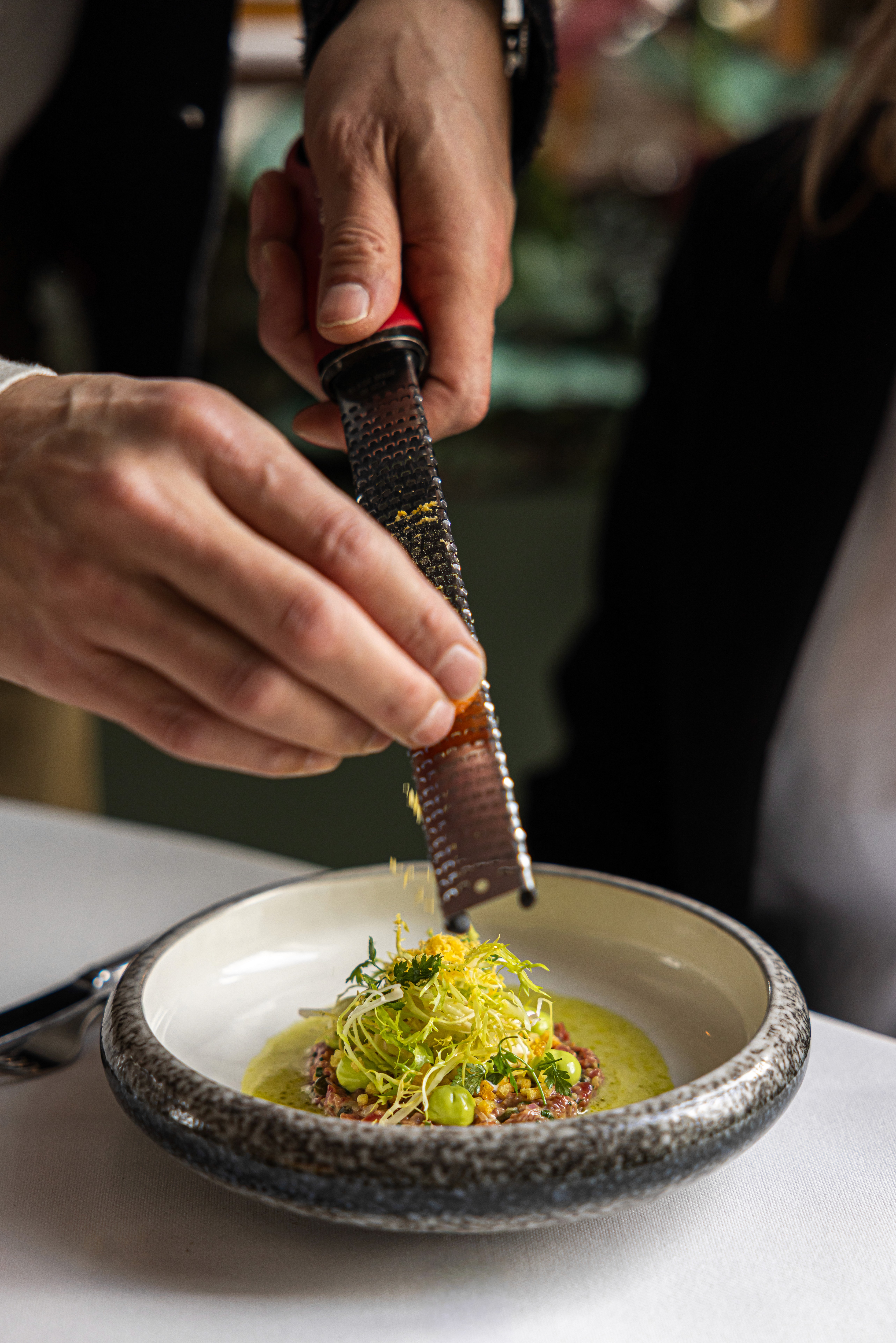 man's hand pouring red wint into a glass