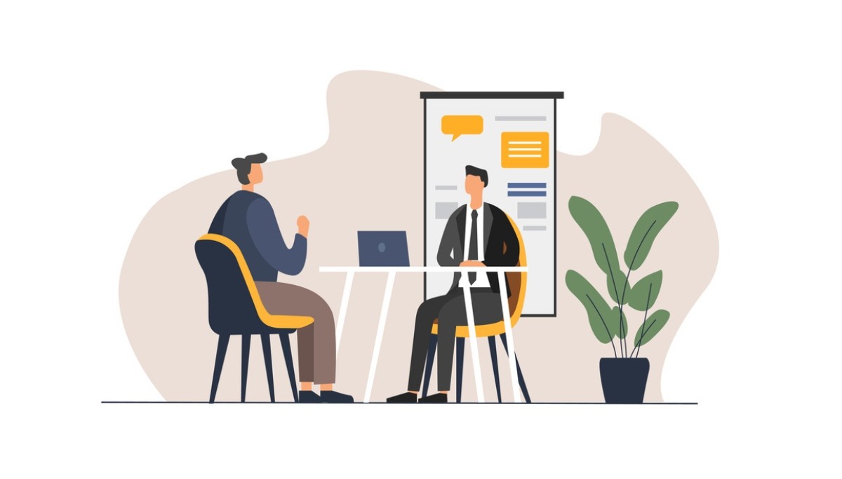 Illustration of two individuals seated across a table in a formal interview setting, with a laptop and presentation board in the background.