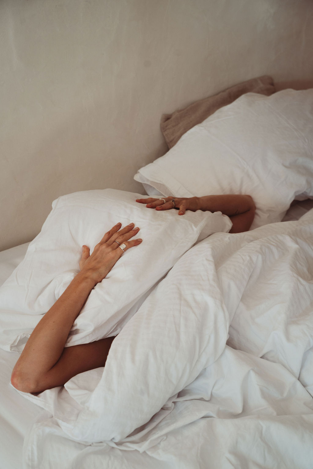 Woman smiling with eyes closed embracing self-love while healing intimacy issues