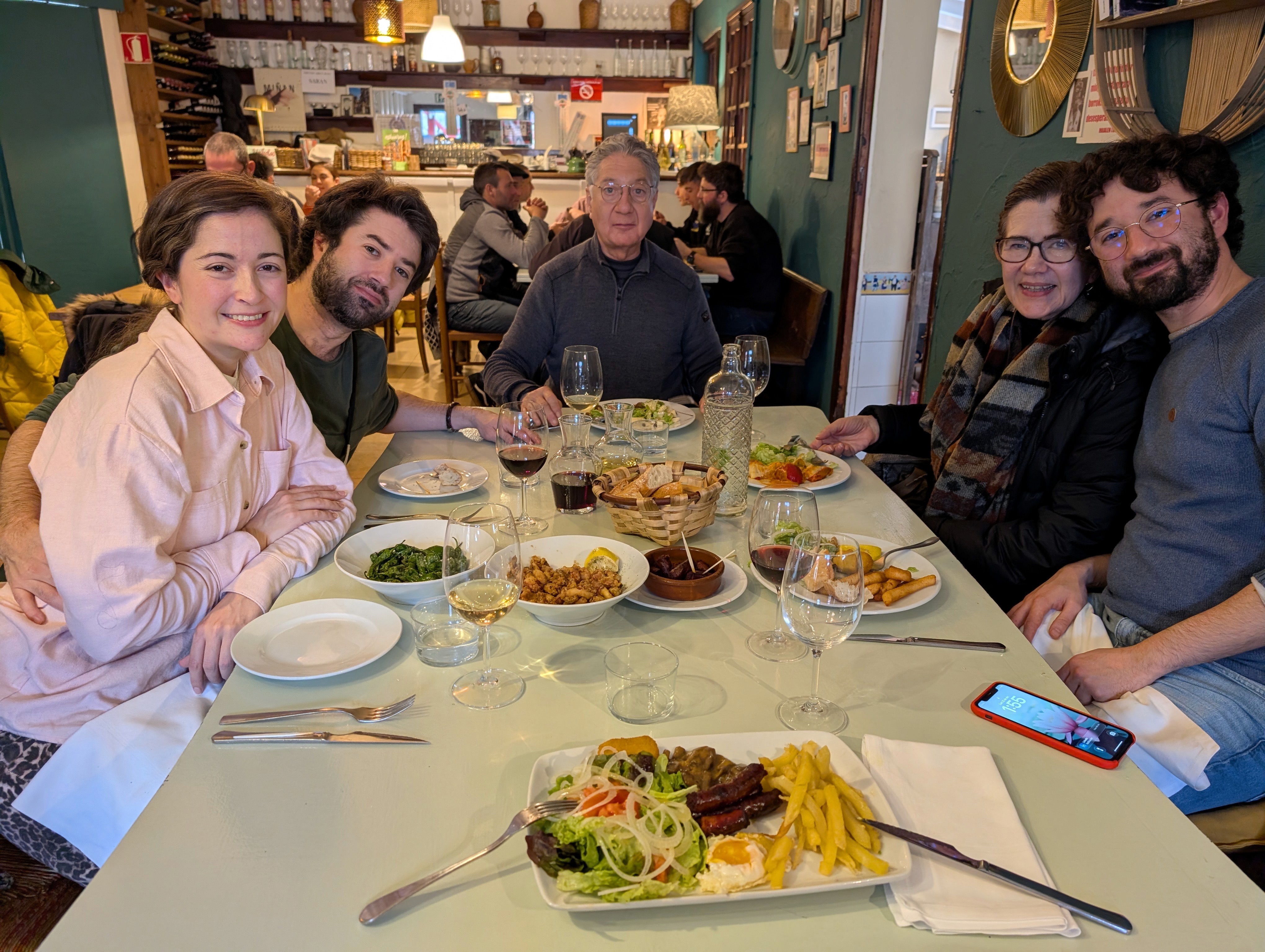 Warm lunch moment at a local restaurant, sharing Basque specialties around the table.