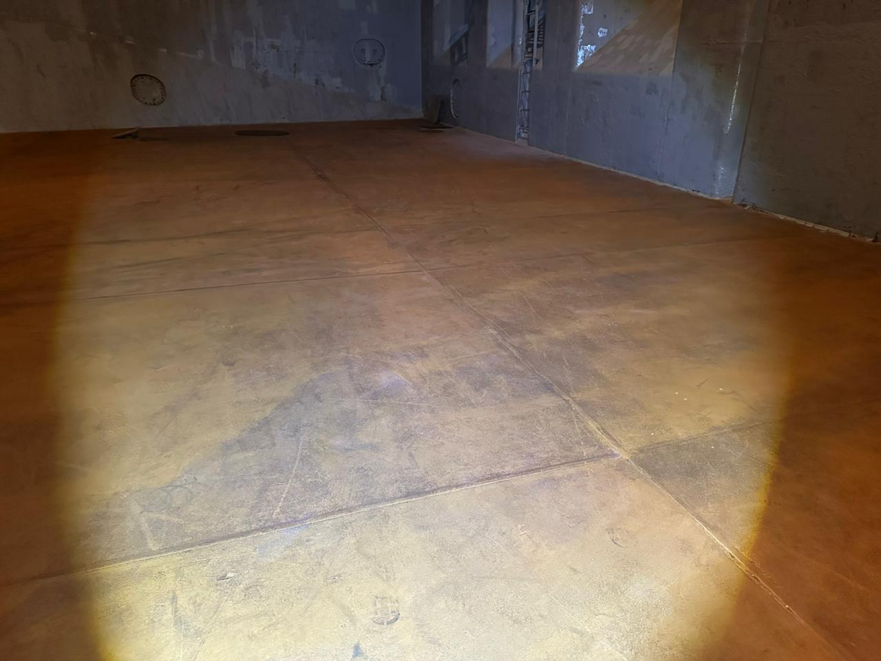 Cargo hold tank top area during UNIGLOBE night holds inspection, checked under portable lighting for cleanliness and dryness.