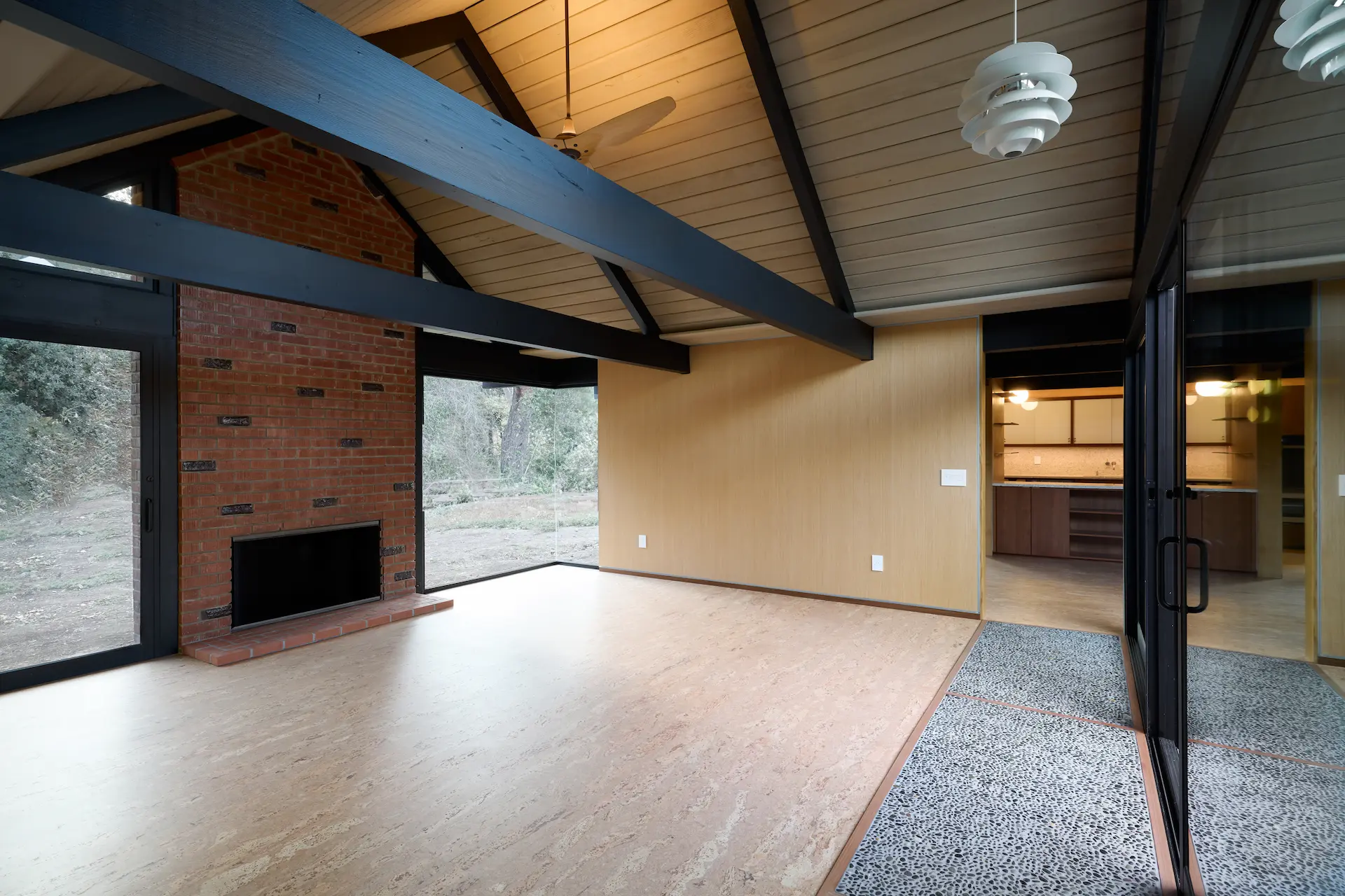 View of the living room, showcasing the open space concept and modern interior design in the Fairhills Eichler Tract home. Photo by Todd Huge.