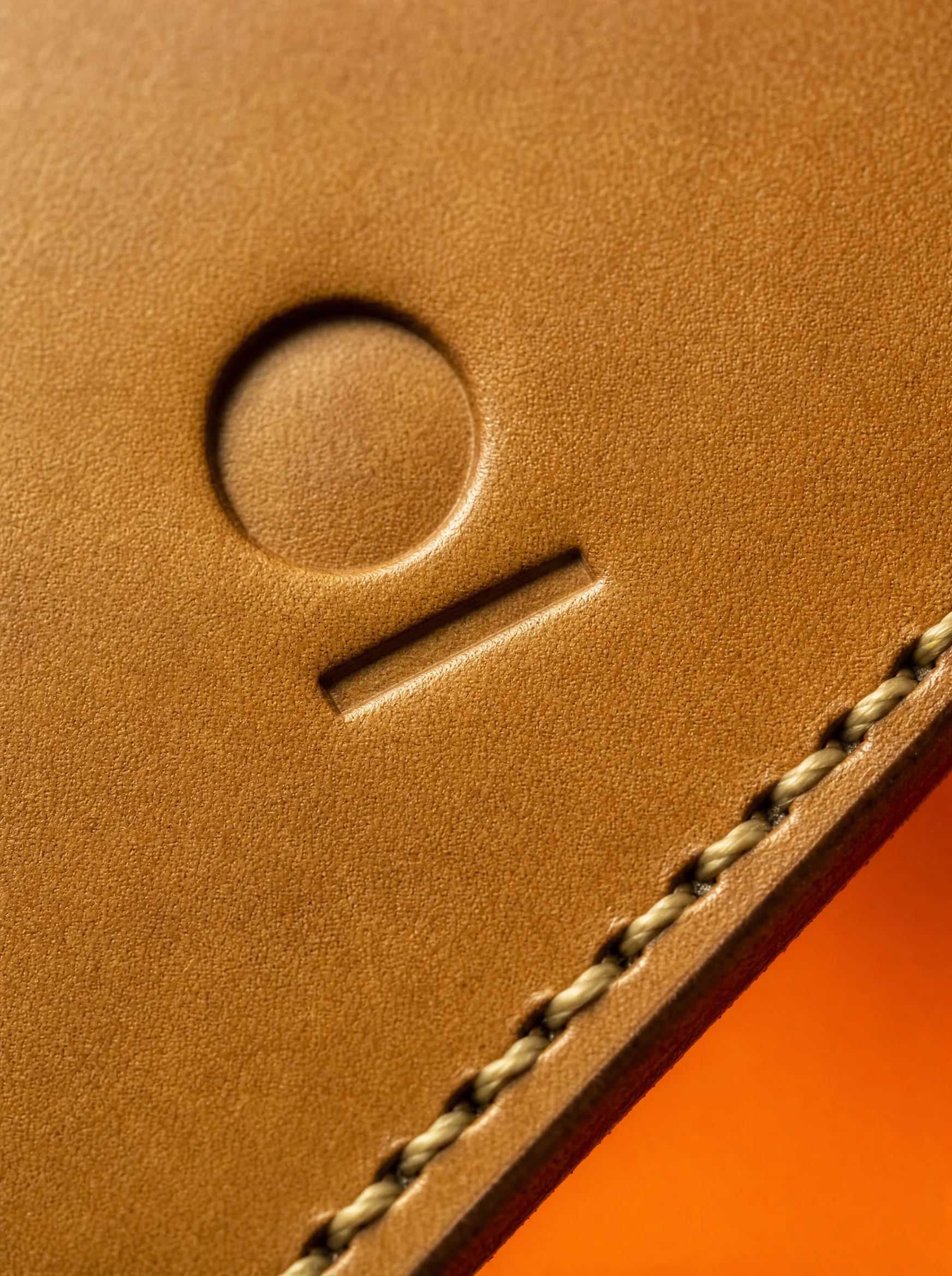 Tan leather with the Studio Pelle mark stamped in, and saddle stitching
