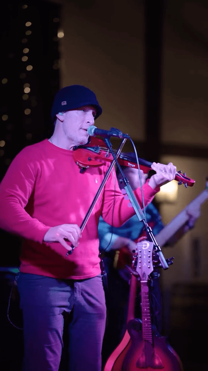 A group of people praticing yoga on the beach in the morning