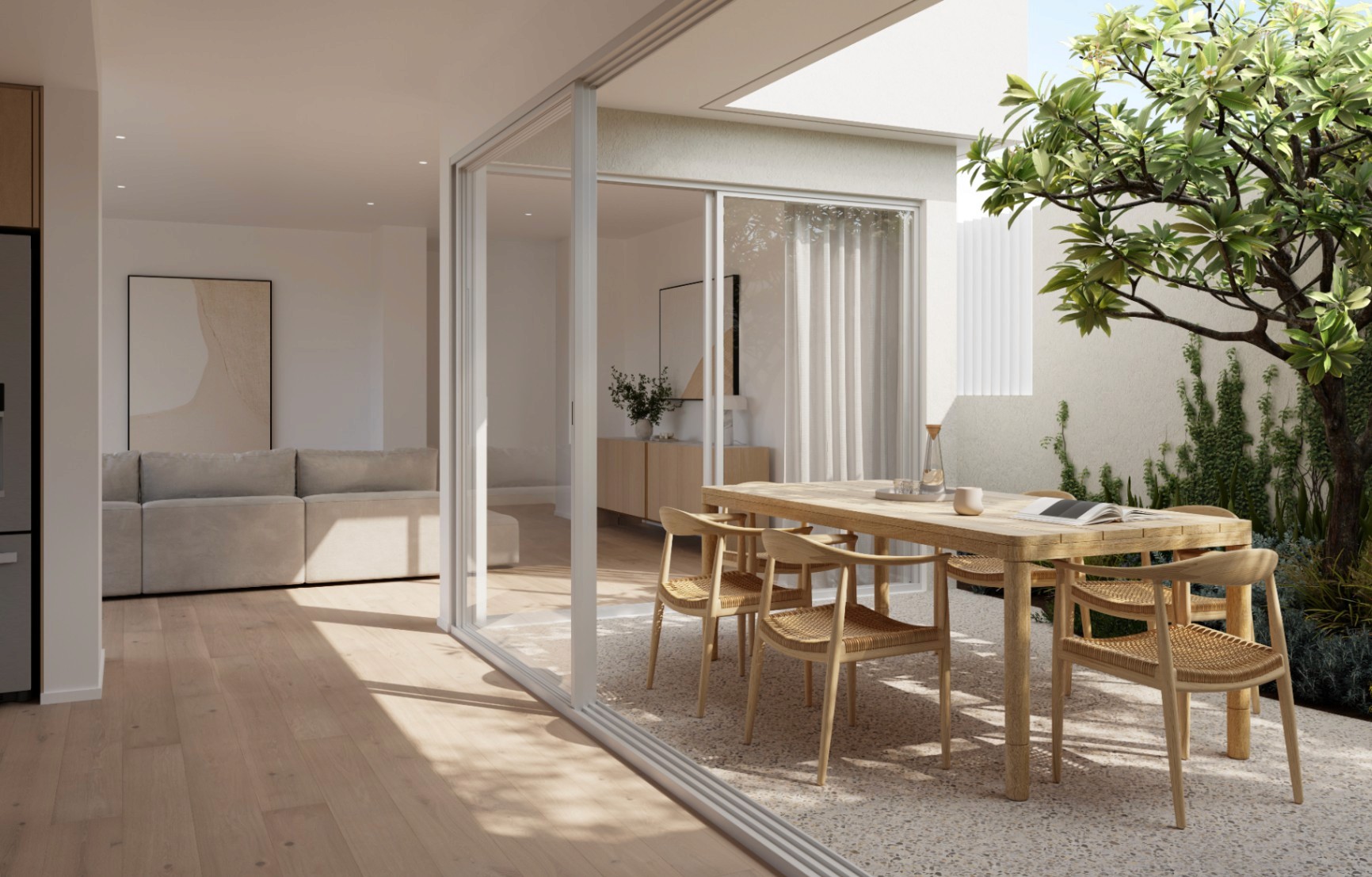 Private courtyard with natural light, timber dining setting, and seamless indoor-outdoor connection in a modern coastal townhouse