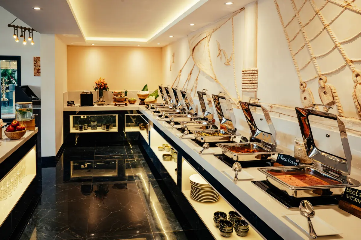Signature Buffet spread at Sarvam, Vedic Village Kodungallur, with chafing dishes of Kerala cuisine along a nautical-themed dining counter