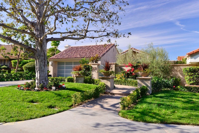 Harbor Ridge Transitional Remodel home exterior with landscaped pathway and lush green lawn.