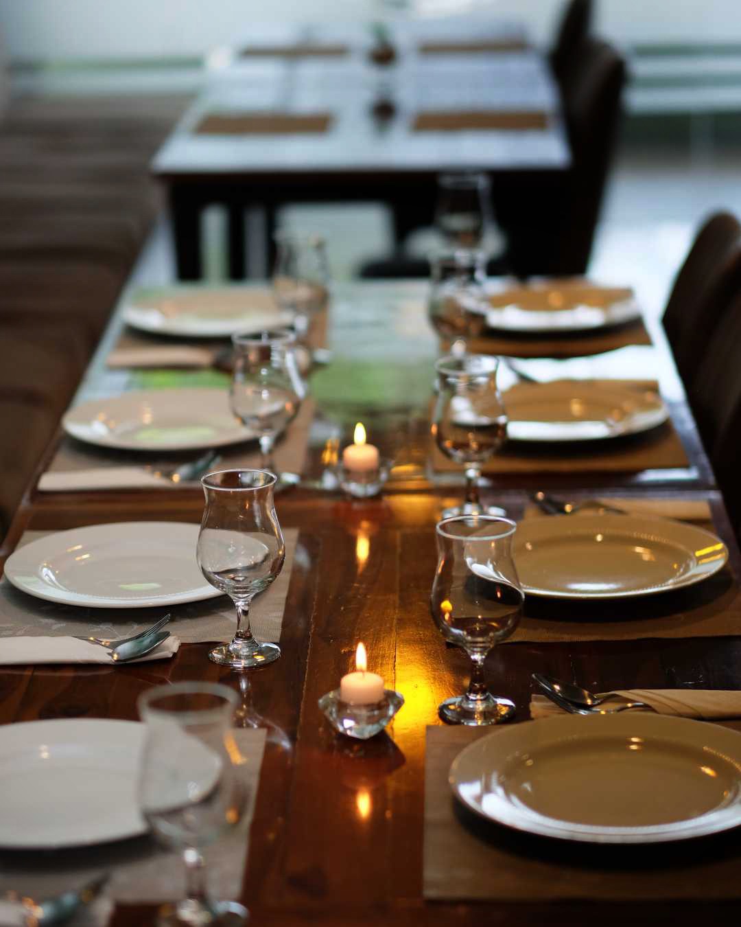 an interior of a fine dining restaurant with focused shot on the table with the plates and glass has been served