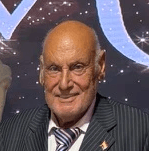 man in black suit jacket smiling