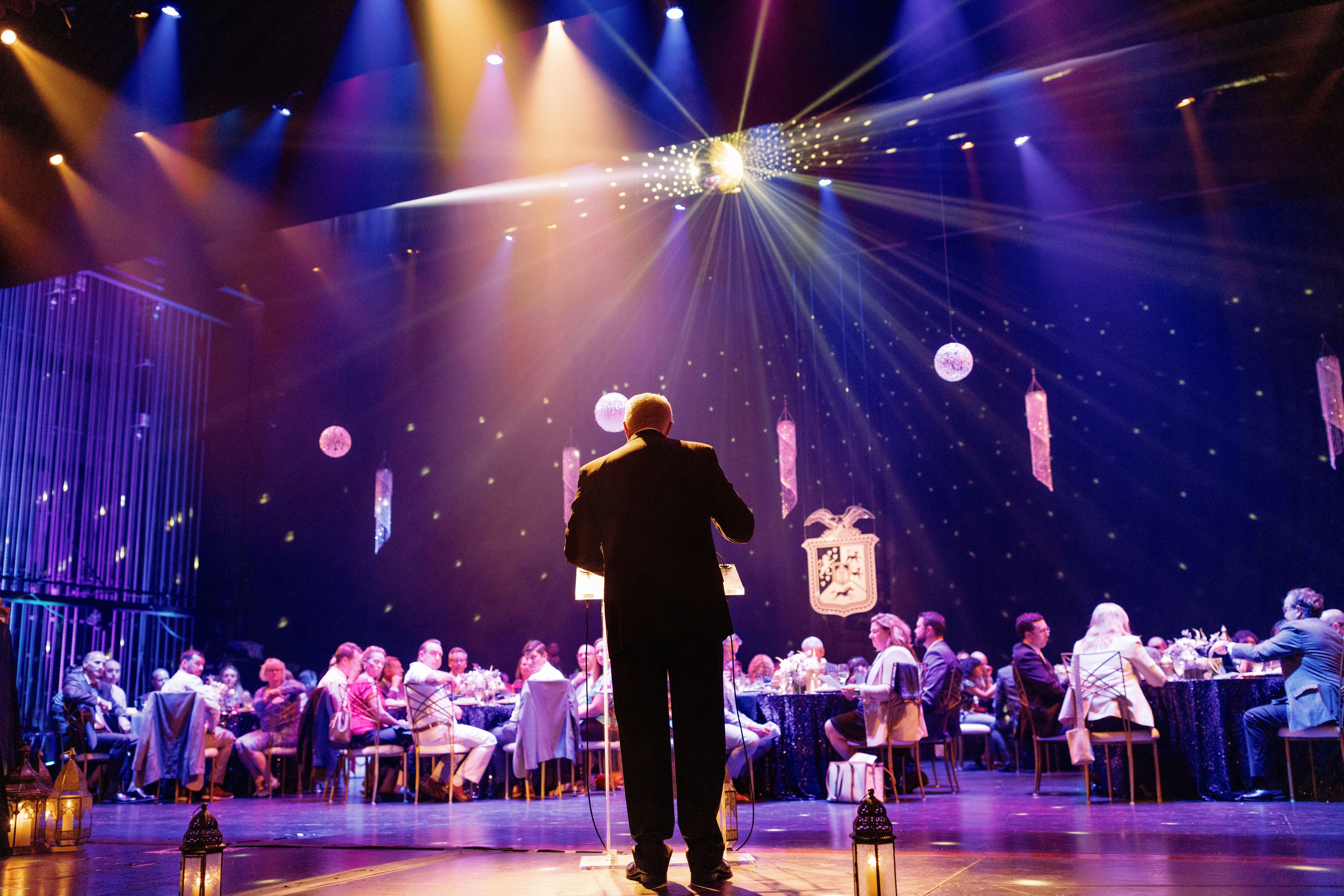 Orchestra conductor performing under a spotlight at the Hanover President's Excellence Awards gala