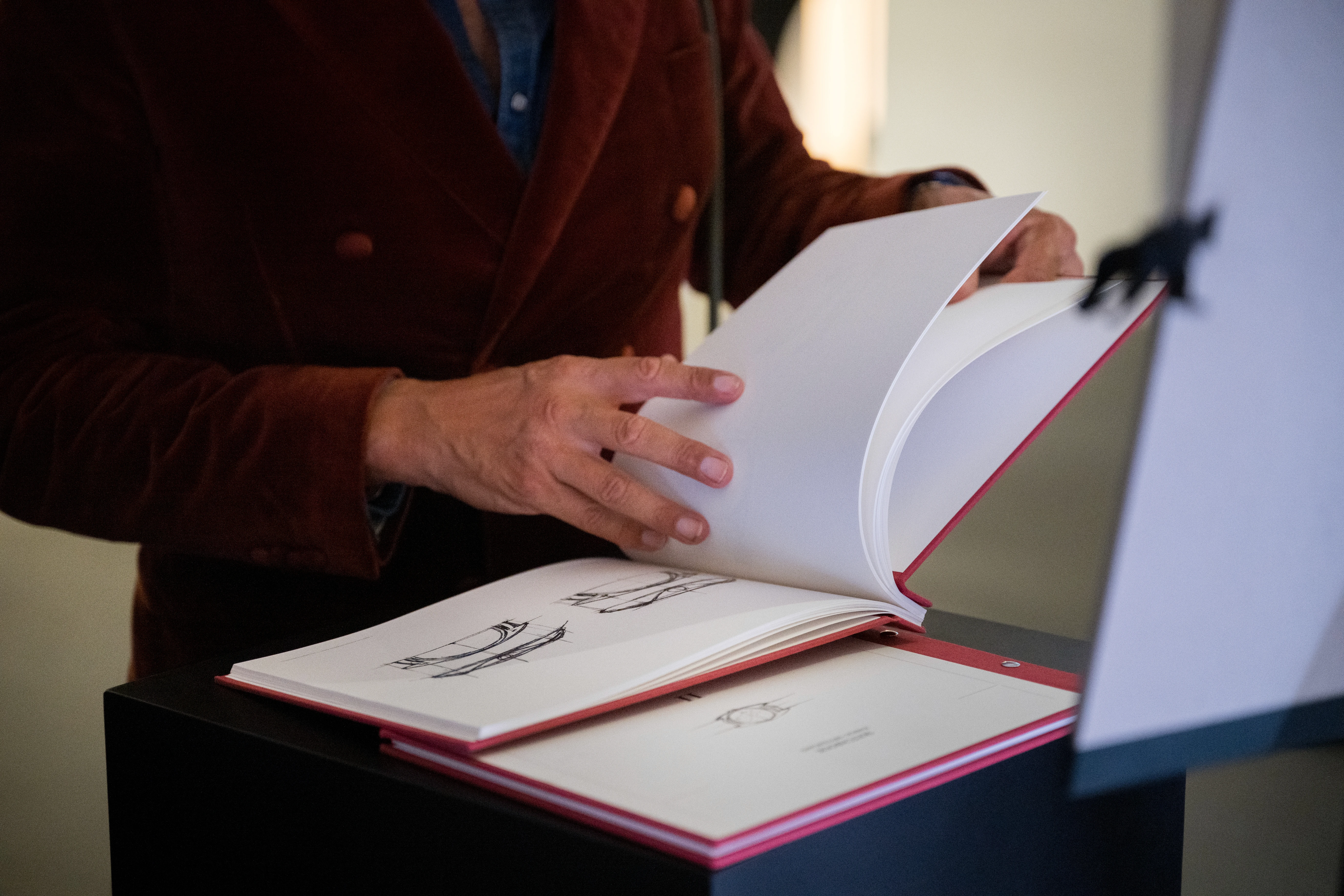 Visitor reading the Gübelin catalog during the launch event
