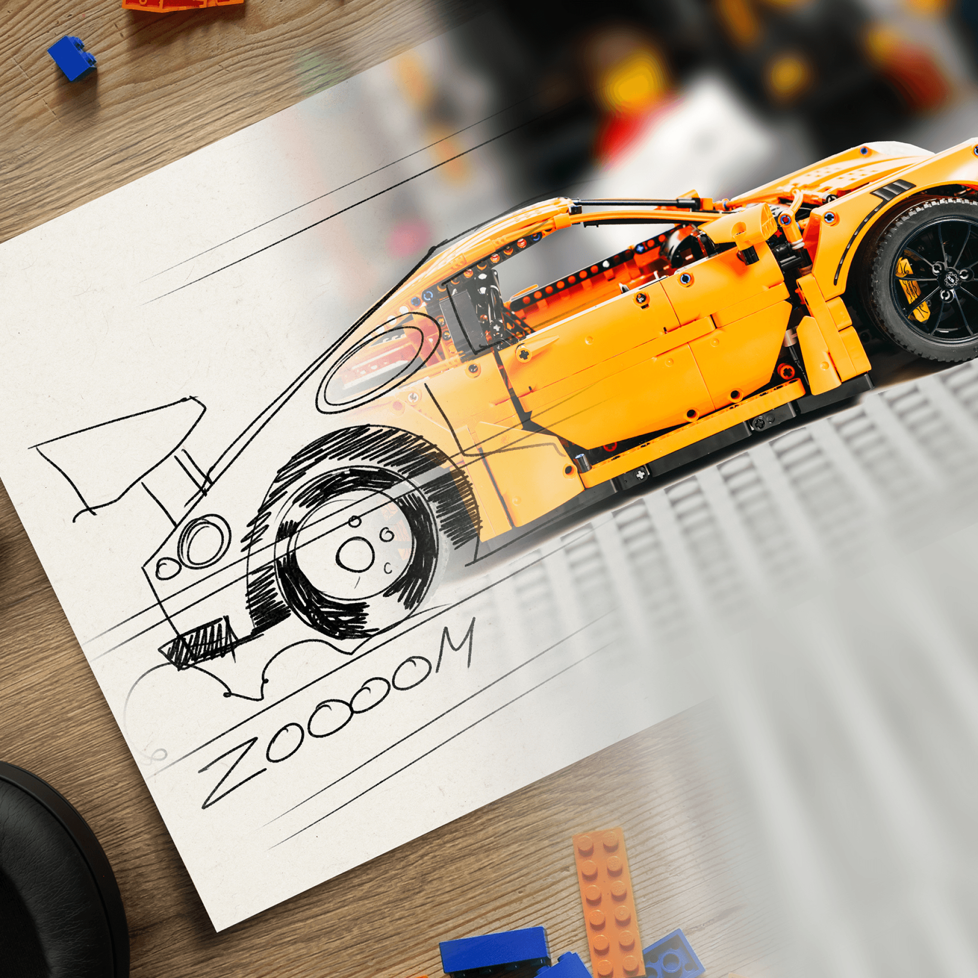 A sketch of a car on paper that, halfway through, turns into an orange LEGO racecar.