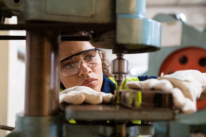 Female engineer using industrial tools