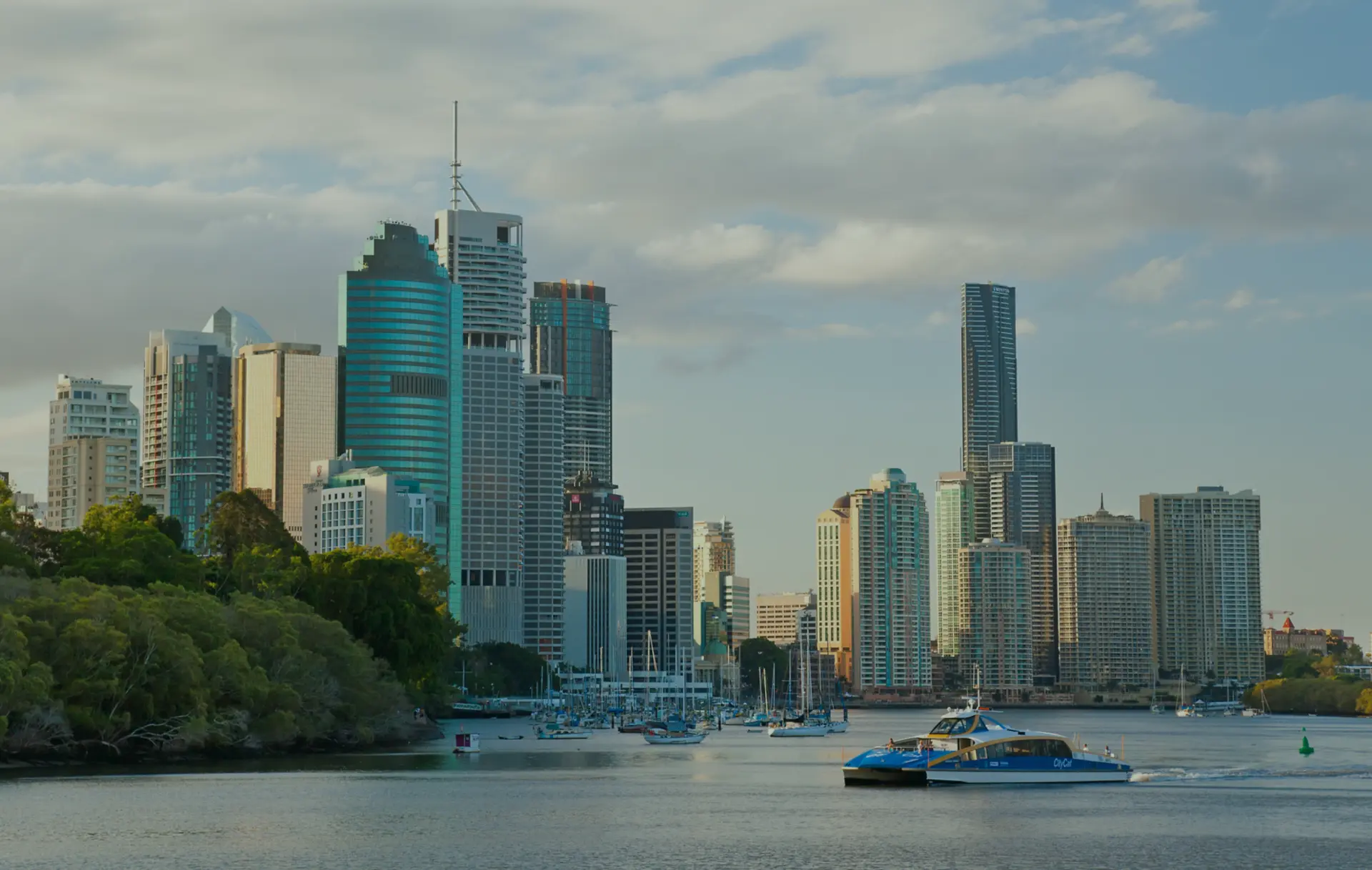 City skyline with a ferry on the water.